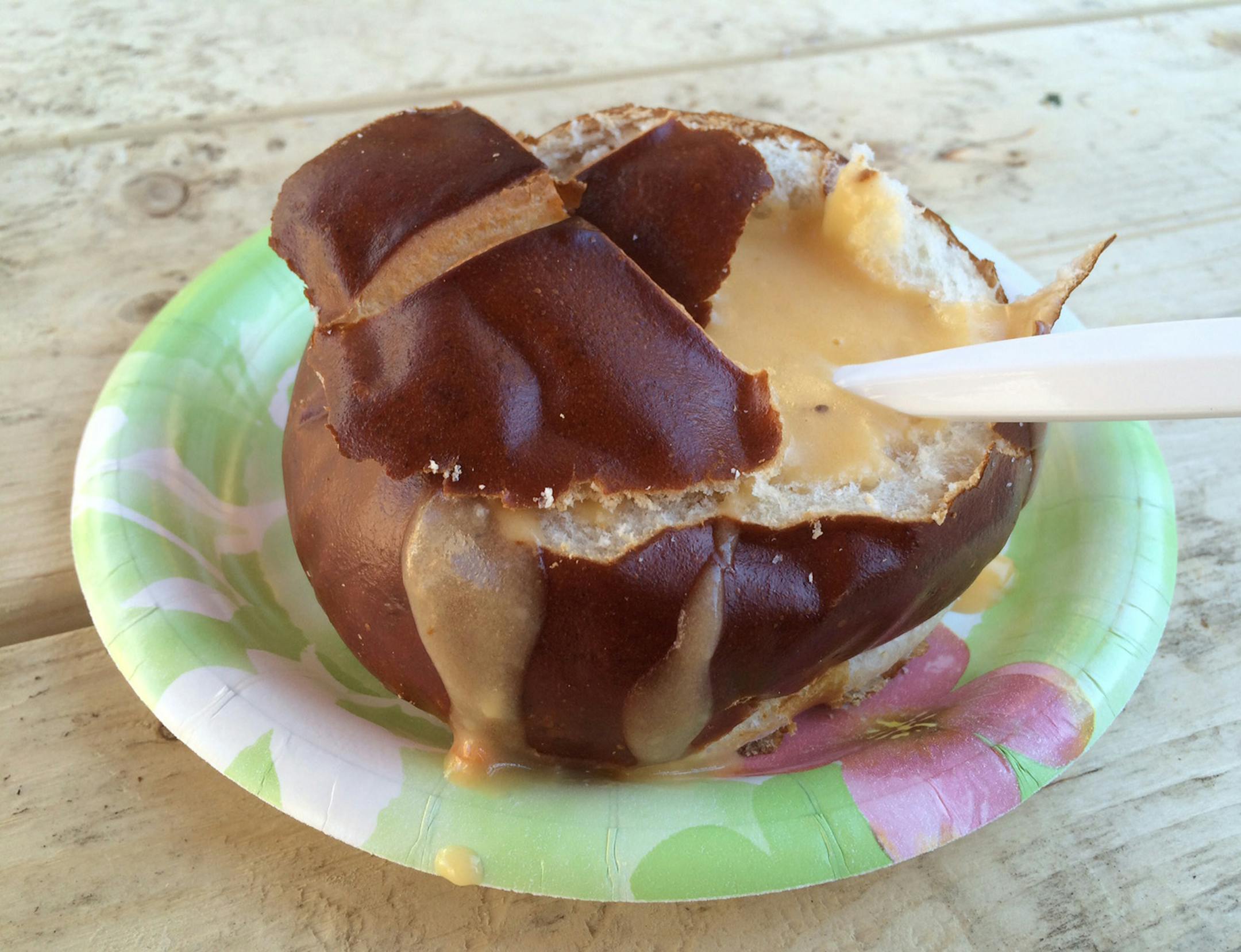Beer cheese soup in a pretzel bun