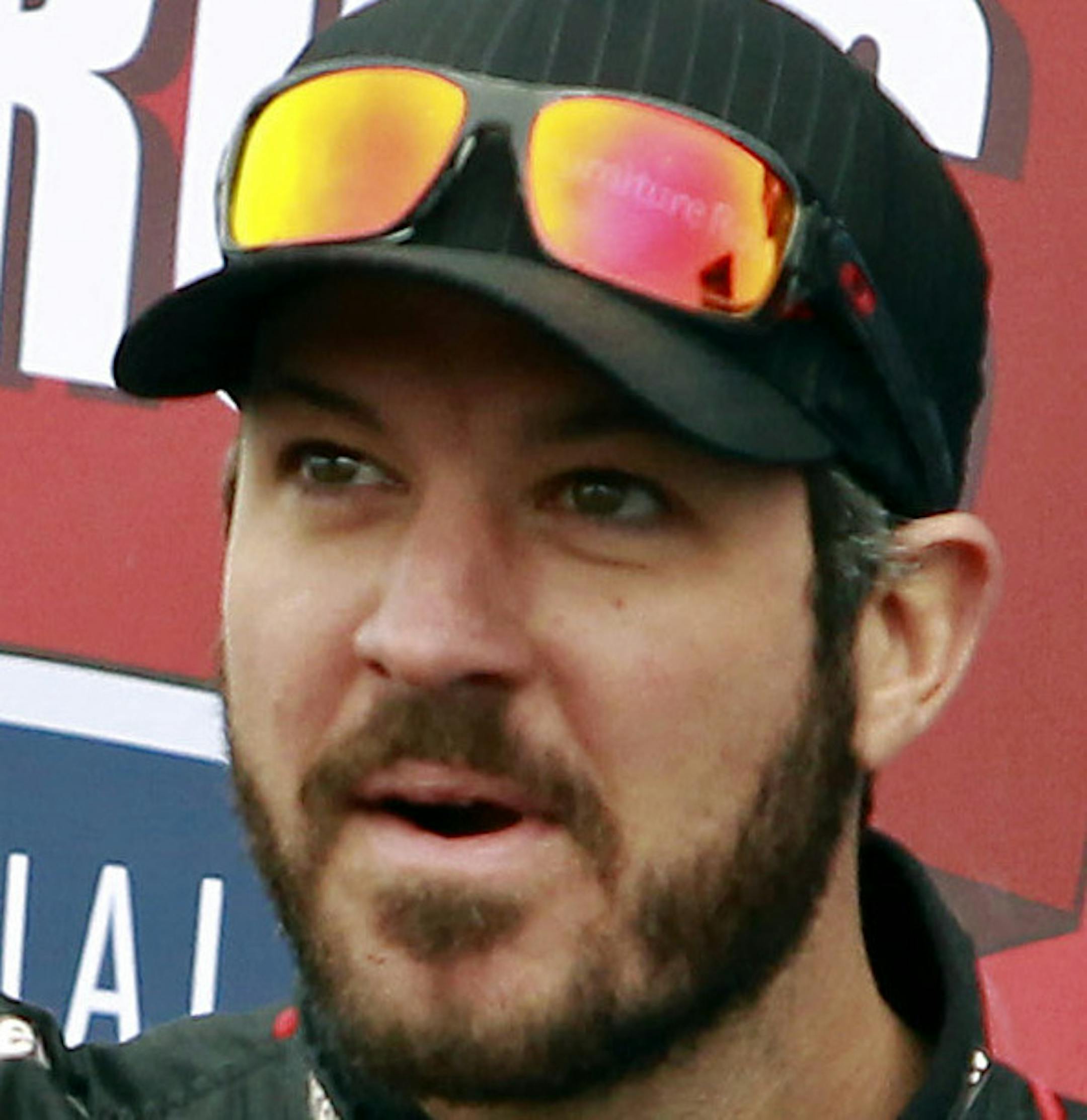 Martin Truex Jr. waves to the crowd during driver introductions before the NASCAR Sprint Cup Series auto race at Phoenix International Raceway, Sunday, Nov. 15, 2015, in Avondale, Ariz. Truex Jr. is one of seven drivers looking to clinch a spot in the final Chase for the Cup Championship race in Homestead, Fla. (AP Photo/Ralph Freso)