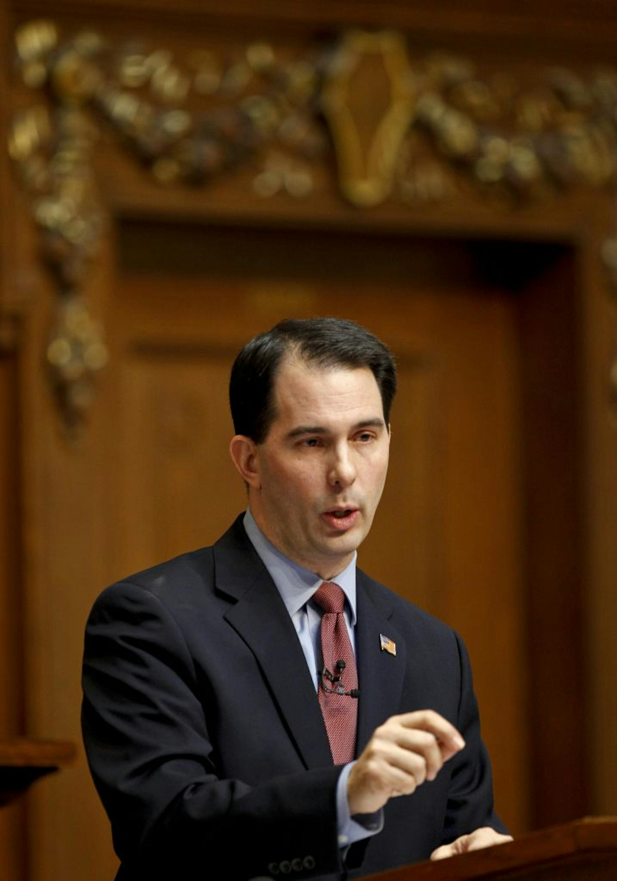 FILE - In this March 1, 2011 file photo, Wisconsin Gov. Scott Walker addresses a joint session of the Legislature at the state Capitol in Madison, Wis. Political foes hoping to recall Republican Gov. Scott Walker over his moves to significantly curb union rights in Wisconsin planned a rally for late Tuesday night, Nov. 14, 2011 and early morning pajama parties to officially kick off the effort. As opponents of Walker begin the massive effort this week of collecting more than half a million signa