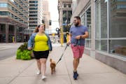 Wendy Fossum and John White Jr. walked their dog, Hamilton, around downtown Minneapolis on Aug. 9.