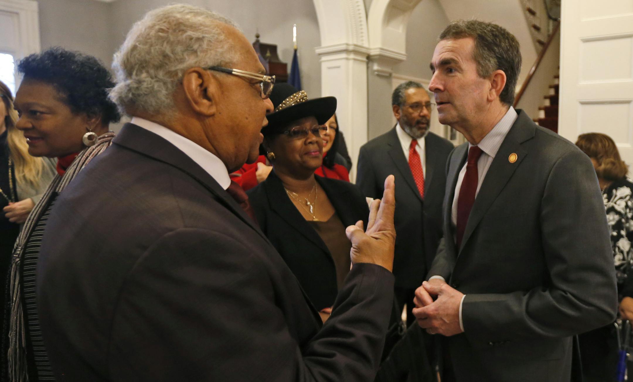 Virginia Gov. Ralph Northam, right, greets a member of the Richmond 34, Leroy Bray and his wife Cynthia, center, for a breakfast at the Governors Mansion at the Capitol in Richmond, Va., Friday, Feb. 22, 2019. The Richmond 34 were a group of African Americans who defied segregation laws in the 1960's (AP Photo/Steve Helber)