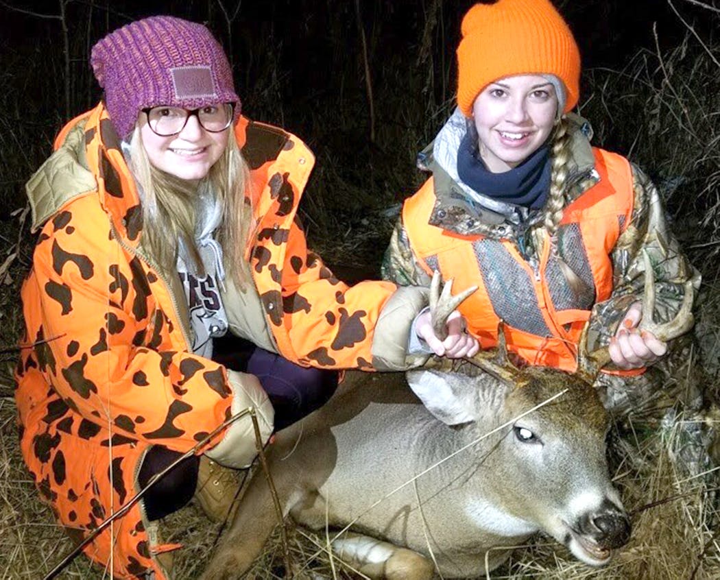 Hunting buddies Calli Cederberg, left, and her cousin Haley Cederberg with Haley's eight point buck. They were hunting with family near Sebeka, Minn., on the last day of firearms season.