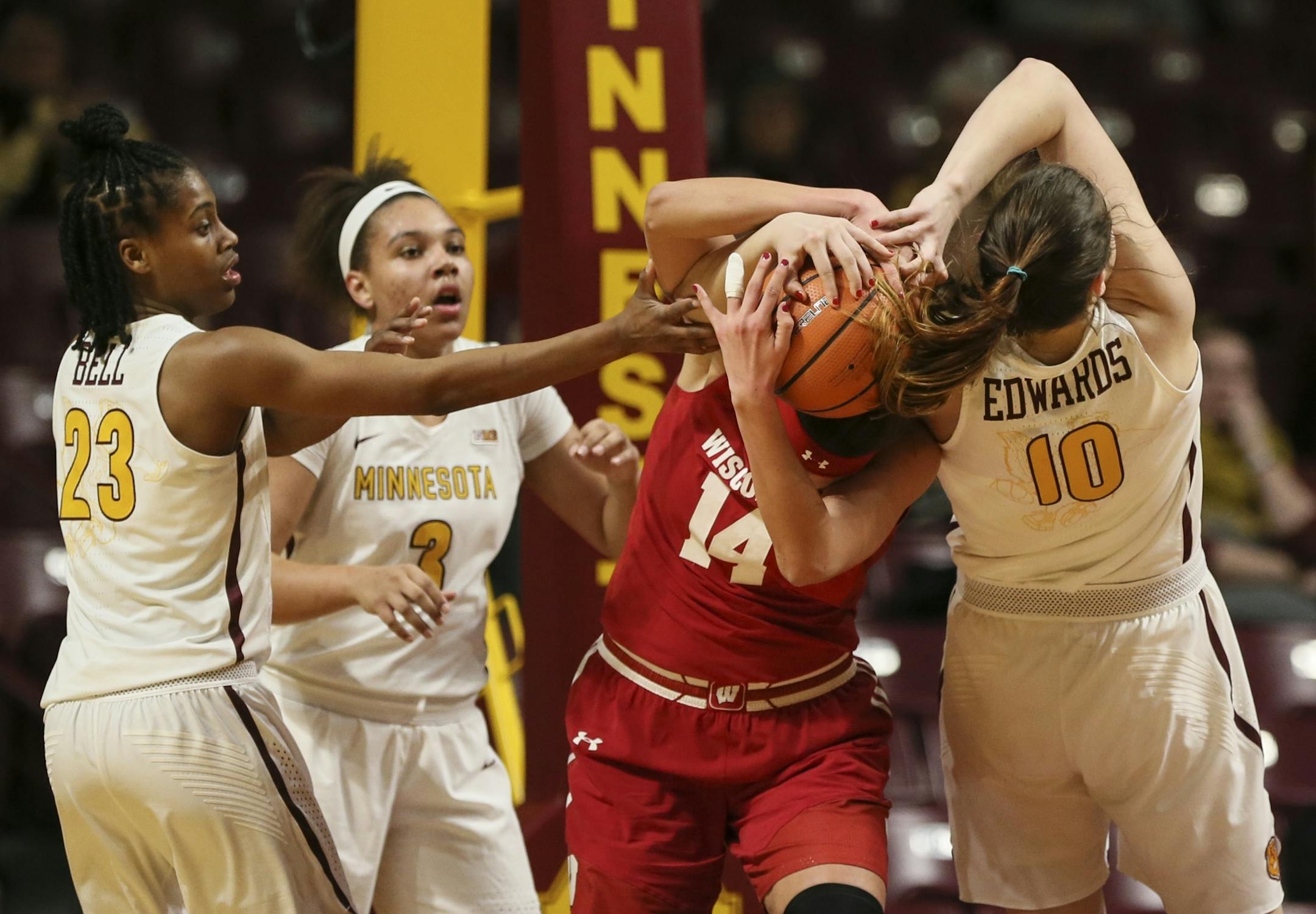 Minnesota Golden Gophers center Bryanna Fernstrom (14) and Wisconsin Badgers guard Kendra Van Leeuwen (10) struggled for the ball in the first half.