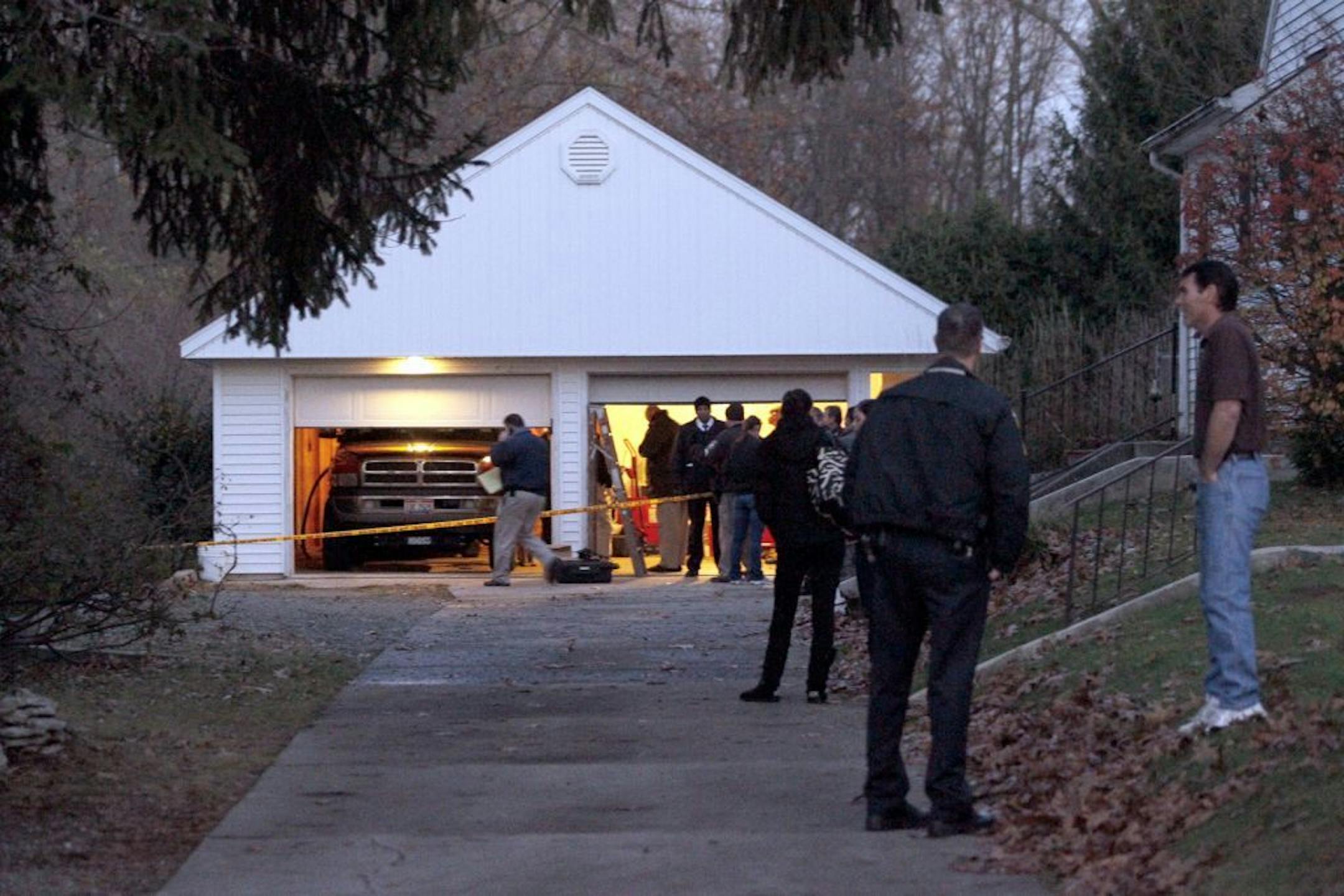 Authorities respond to a report of carbon monoxide poisoning on Harvest Lane in Toledo, Ohio, on Monday, Nov. 12, 2012. The bodies of three children and two adults were found inside the garage Monday, and authorities said they believe the deaths � apparently from carbon monoxide poisoning � weren't accidental.