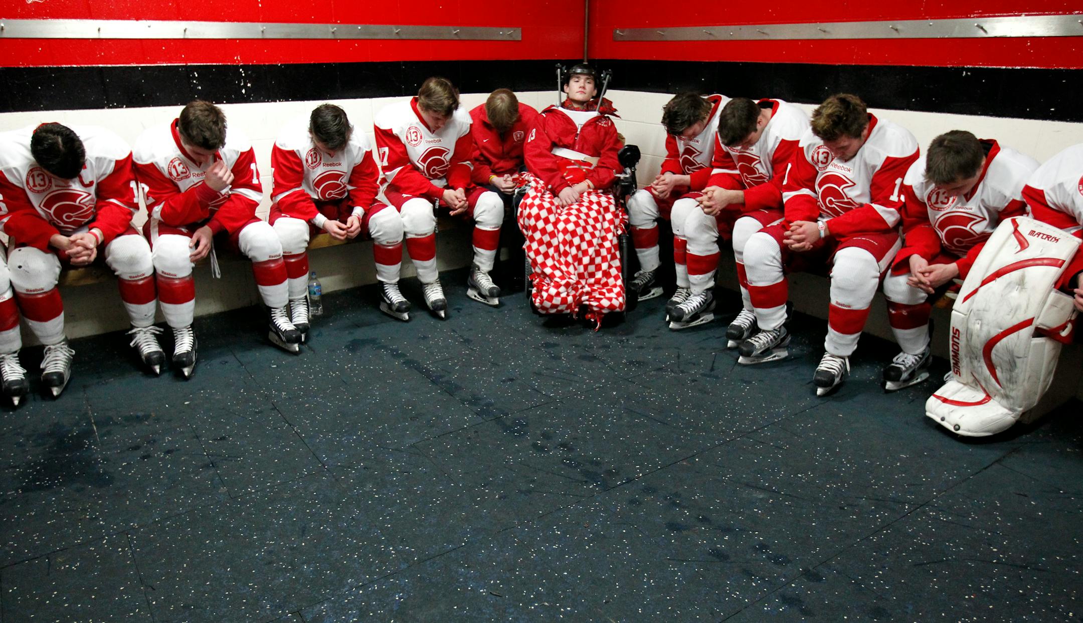 With teammate Jack Jablonski in the locker room, Benilde-St. Margaret's players bowed their head in prayer before Thursday night's section playoff game at St. Louis Park Recreation Center.