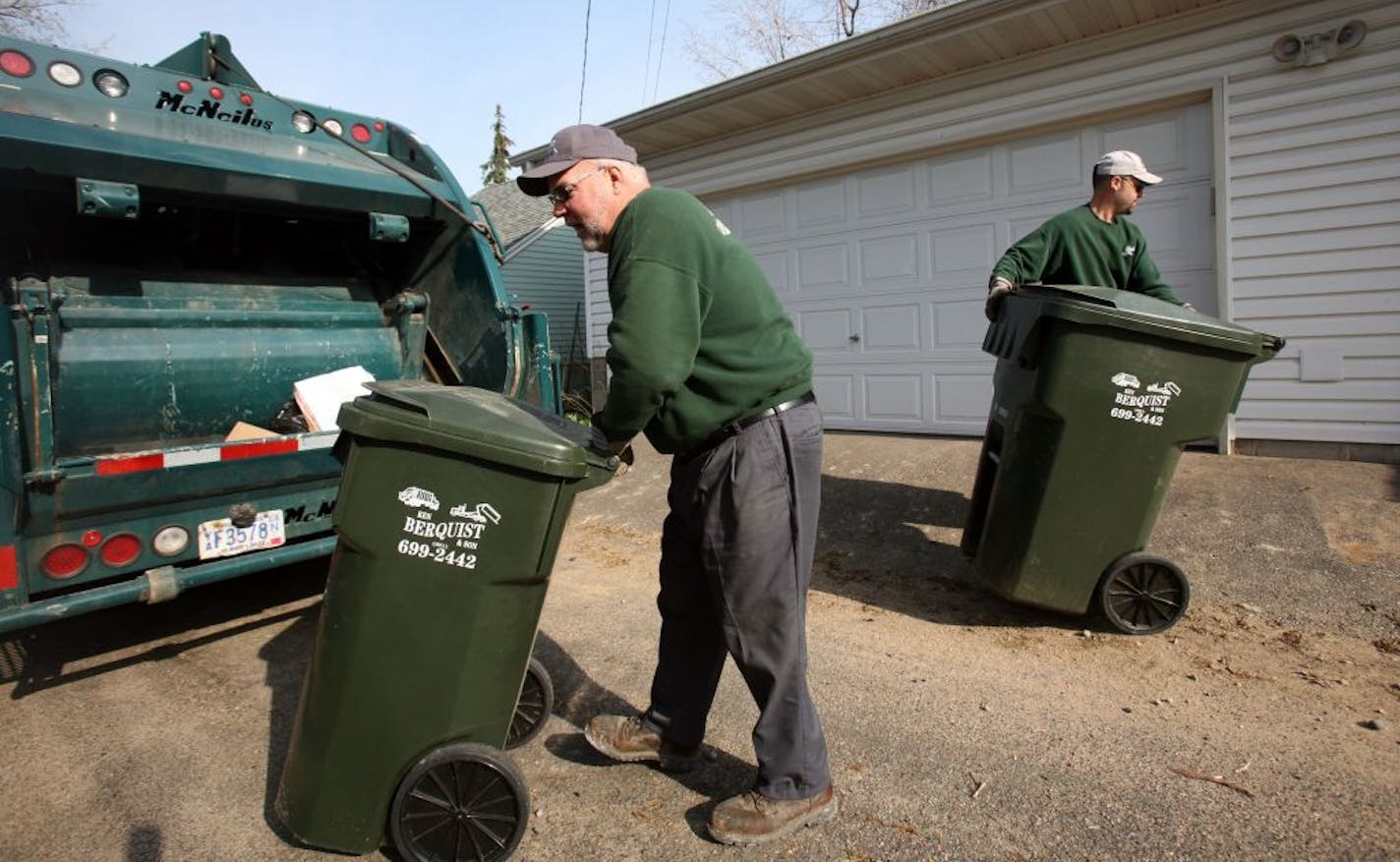 KYNDELL HARKNESS � kharkness@startribune.com Jim Berquist wheeled a trash can toward the back of the garbage truck while his son Mike put one back in it's place during their route in St. Paul. This alley between Sargent and Princeton one neighbor, Todd Seabury-Kolod, got his neighbors to get the same garbage company.