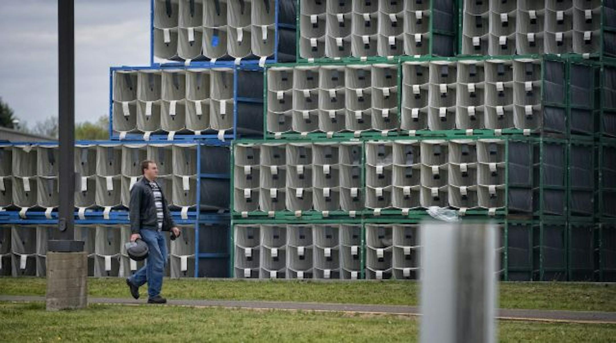 A Polaris worker passes empty shipping containers as he left the plant during lunch break. Polaris announced Thursday they will be closing the plant.