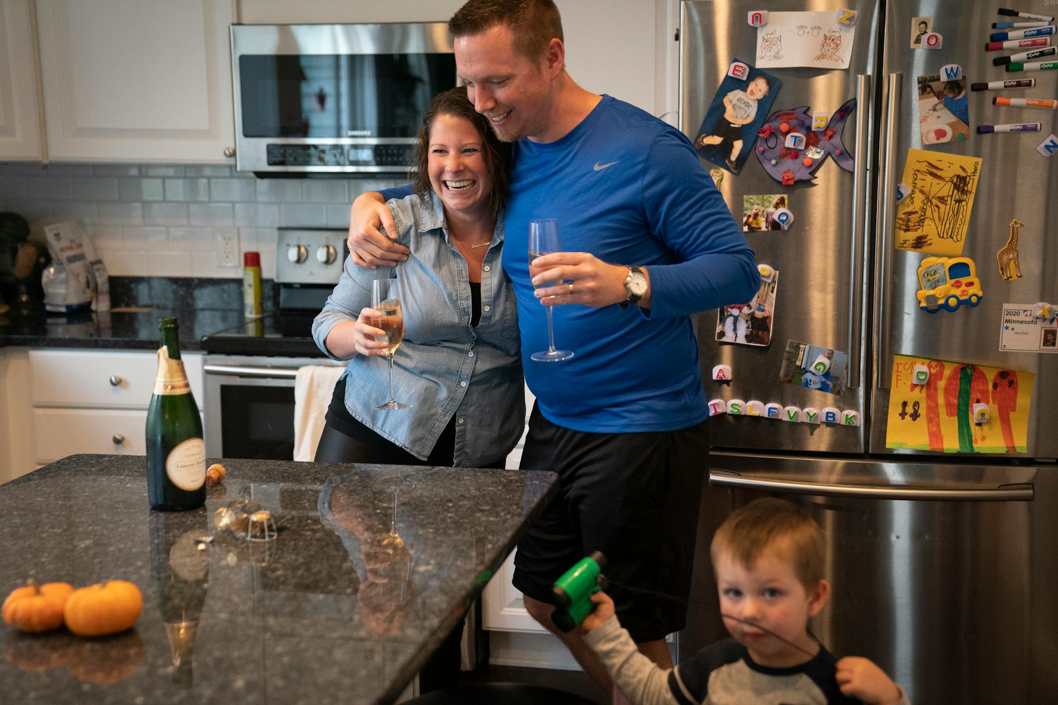 Jenna and Eric Fink of Savage celebrated after Joe Biden was named the winner of the presidential election on Saturday. They had been chilling a bottle of Champagne since election night with the hopes of popping it for a Biden win. In the foreground is their son Harris, 2.