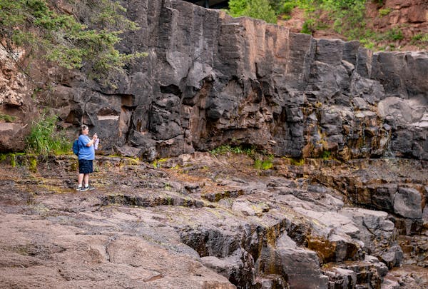 A visitor took a picture of the dried up western falls at Gooseberry Falls State Park on Wednesday, July 21, 2021. Sections of the falls have dried ou