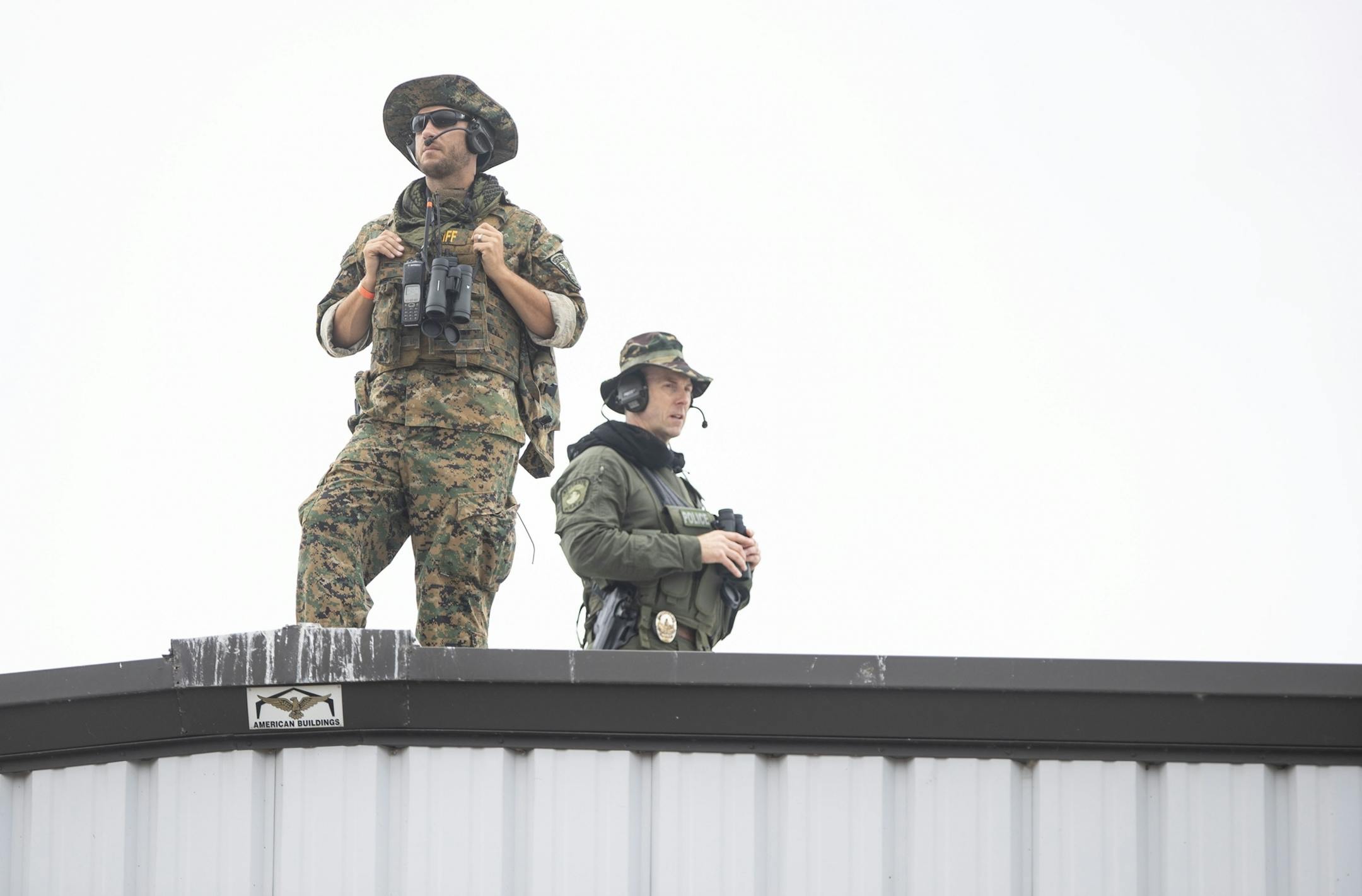 A pair of law enforcement officers from the St. Louis County Sheriff's office stood on the roof of Lake Superior Warehousing during Vice President Mike Pence's campaign event on Friday in Duluth.