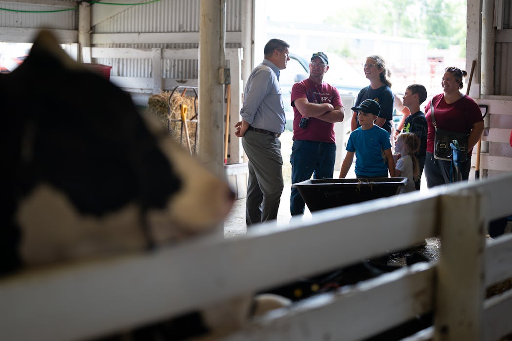 Brad Finstad, left, talked with Scott Brogan and his family as he campaigned at the Olmsted County Fair.