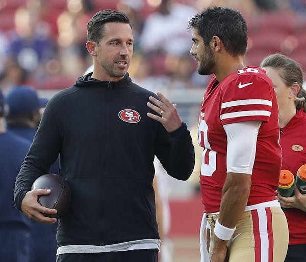San Francisco 49ers head coach Kyle Shanahan, left, talks with quarterback Jimmy Garoppolo (10) before an NFL preseason football game against the Dall