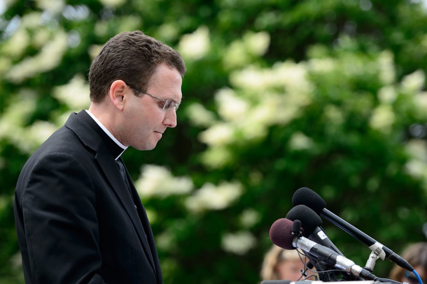 Auxiliary Bishop Andrew Cozzens spoke to the media outside the Archdiocese of Saint Paul and Minneapolis in the wake of Archbishop John Nienstedt's resignation. With him is director of communications Tom Halden.