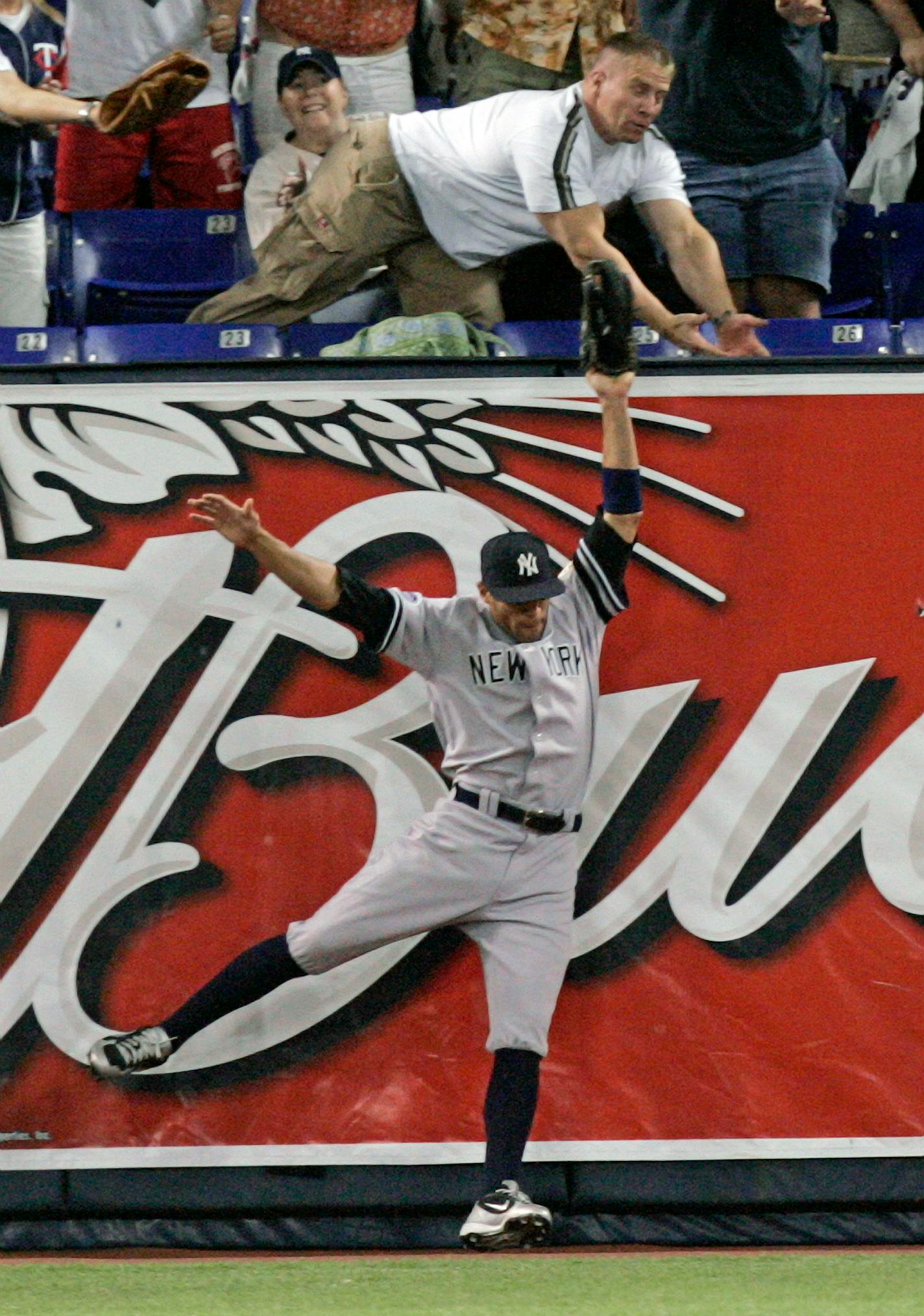 Yankees left fielder Justin Christian became acquainted with the Metrodome wall as a fan dived over the seats to retrieve Adam Everett's second home run of the season with the Twins.