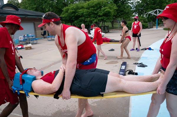 Lifeguards-in-training Elijah Stende, left, Riya Chattopadhyay, Mitchel Roettger and Karinna Borgstrom participate in a rescue exercise during a train