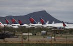 Tail fins of Delta Air Lines planes at Pinal Airpark, in Red Rock, Ariz., as many passenger planes are being kept at the facility as airlines cut back