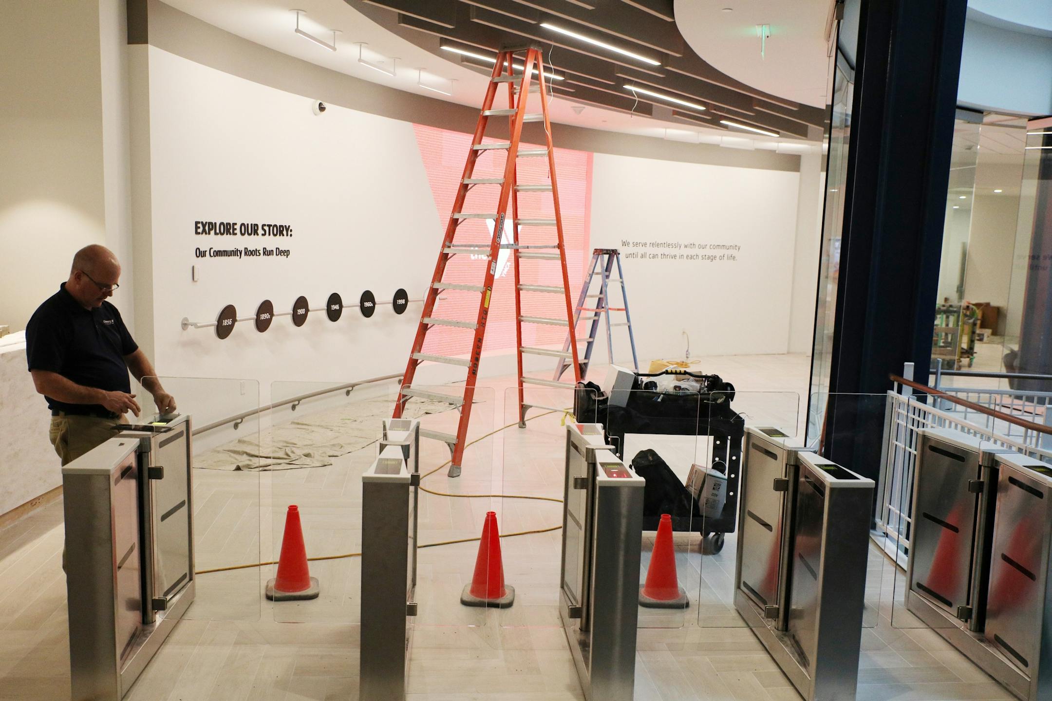 A technician calibrated the turnstiles in the main entryway.