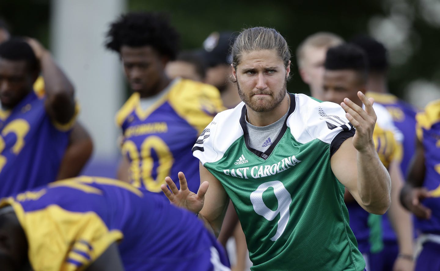 In this photo taken Thursday, Aug. 11, 2016, East Carolina quarterback Philip Nelson (9) calls a play during an NCAA college football practice in Greenville, N.C. (AP Photo/Gerry Broome)