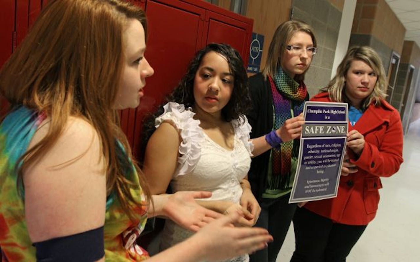 (left to right) Champlin High School Students Emily Boevers, Gina Gainous, Rebecca Dearing and Shannon Haver took a break from a Gay Straight Alliance meeting to talk about the two fellow women students who wanted to attend a school assembly as a same sex couple. Dearing and Haver were holding a sign that hangs in every class room declaring Champlin Park High School as a safe zone.