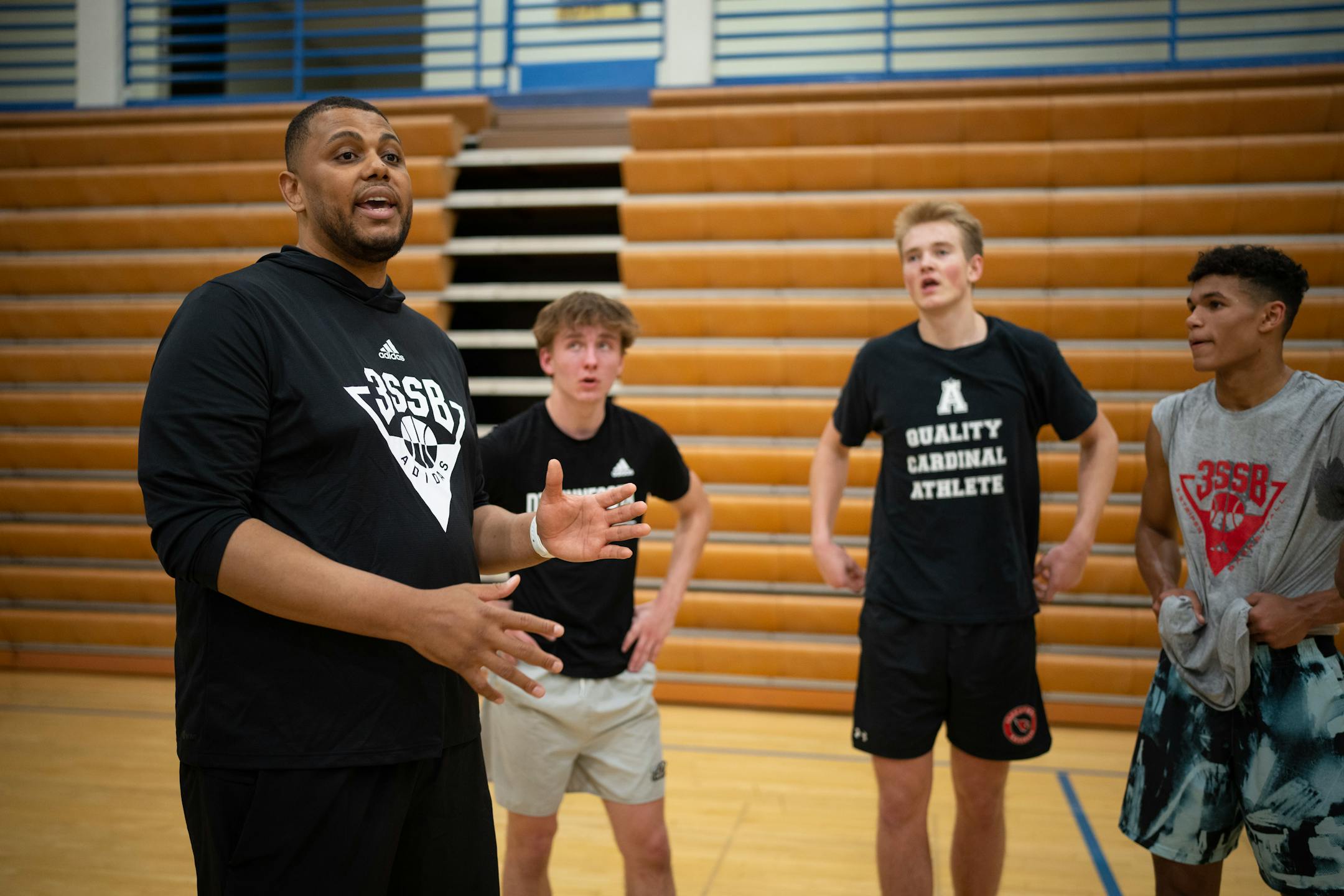 Head coach Jonathan Williams spoke to his team at the end of practice, including Grayson Grove, second from right, and Isaac Asuma, right, at Wayzata Central Middle School in Plymouth.
