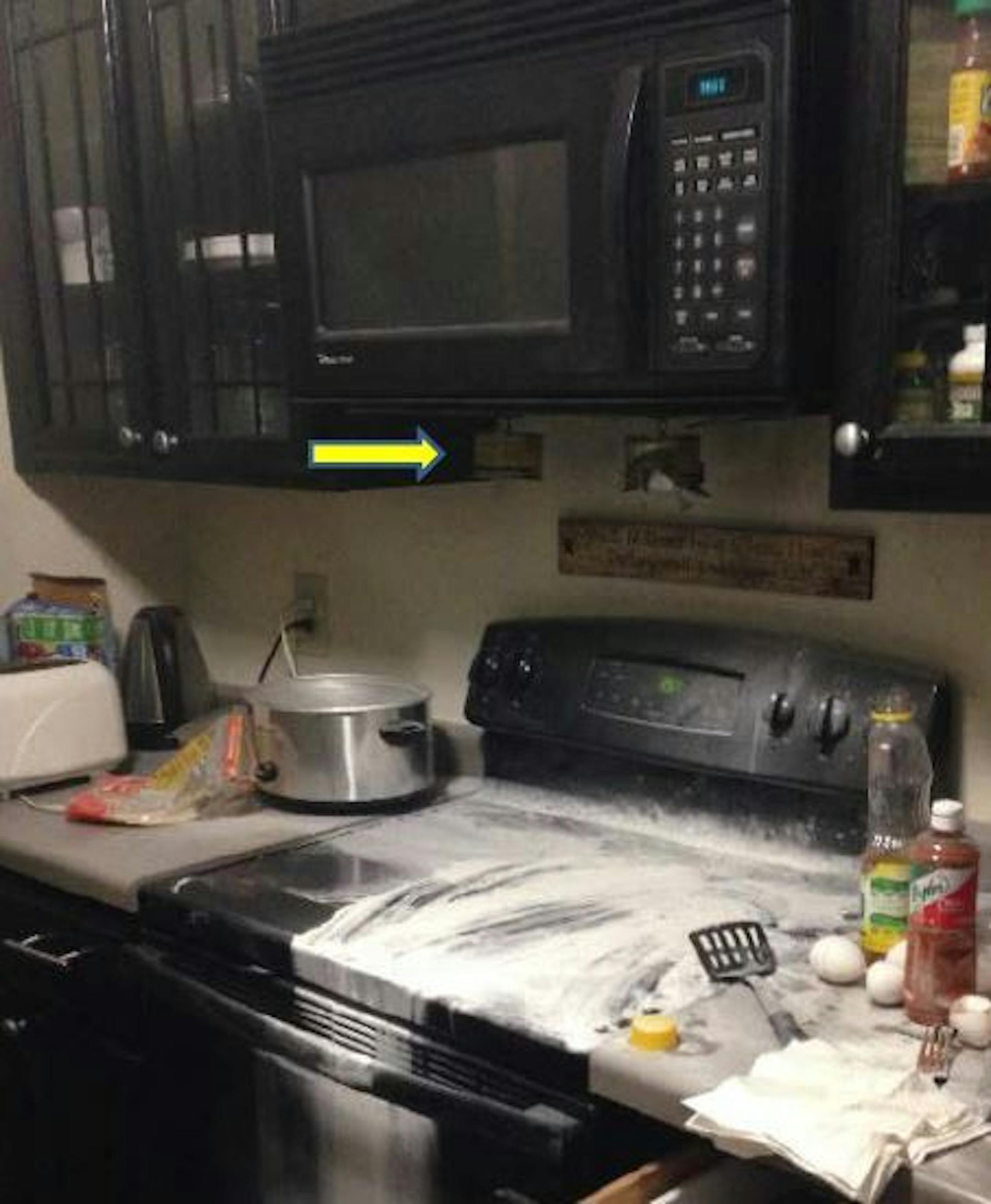 This photograph shows two Stove-Top Fire Stop devices in place above the range top. The device over the fire activated and extinguished the flame.