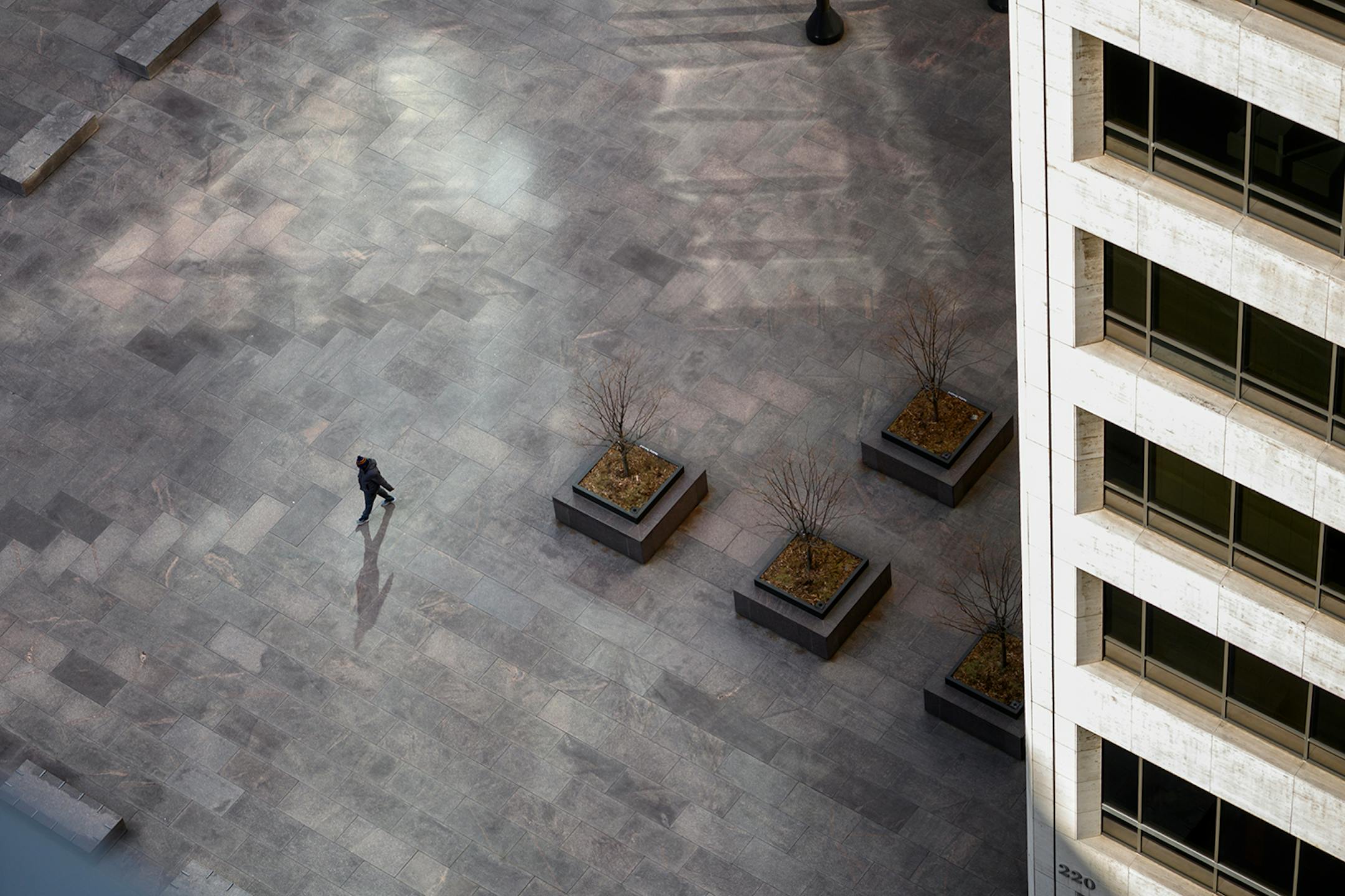 A lone pedestrian walked through US Bank Plaza in downtown Minneapolis on March 26.