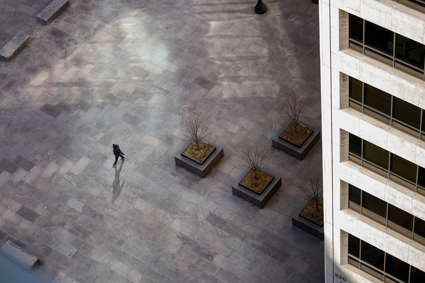 A lone pedestrian walked through US Bank Plaza in downtown Minneapolis on March 26.