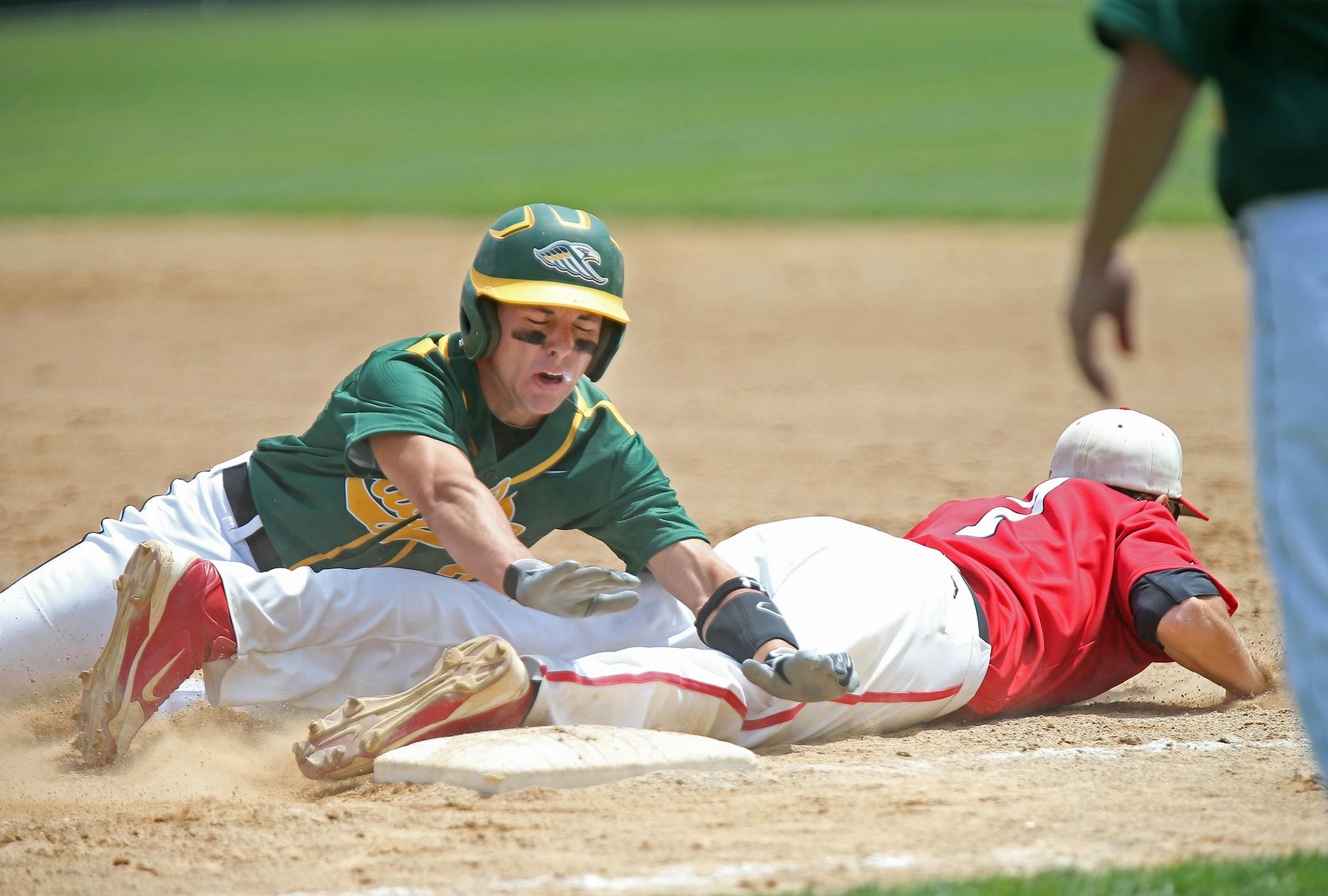 New Life Academy's Alex Busch slid safely into first as BOLD's Riley Kramer missed the ball for an error in the sixth inning of the Class 1A baseball semifinals at the Chaska athletic park, Thursday, June 12, 2014 in Chaska, MN. ] (ELIZABETH FLORES/STAR TRIBUNE) ELIZABETH FLORES • eflores@startribune.com