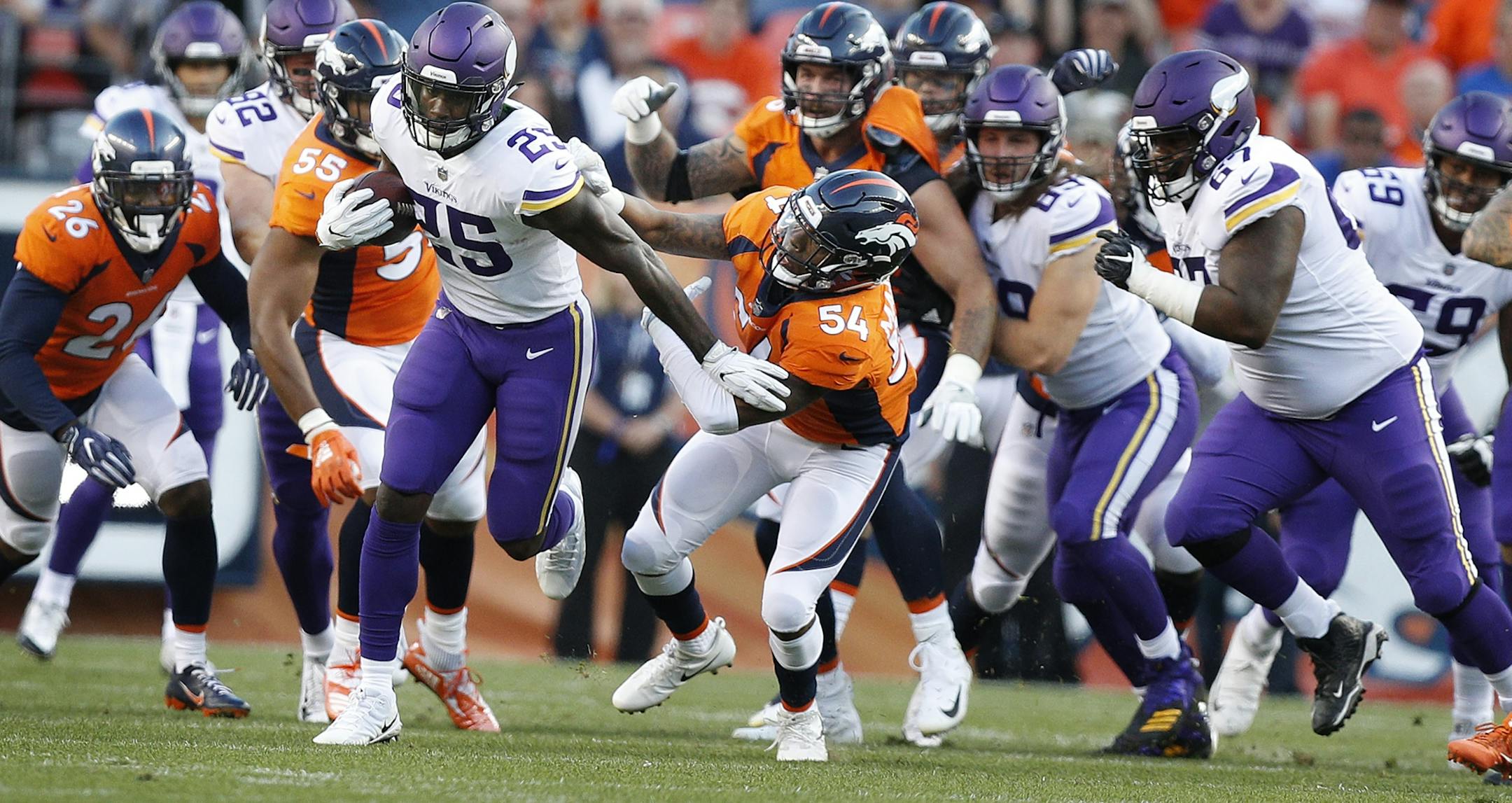 Minnesota Vikings running back Latavius Murray (25) broke the tackle of Denver Broncos linebacker Brandon Marshall (54) picking up 20 yards on the play Saturday August 11, 2018 at Broncos Stadium at Mile High in Denver, CO.