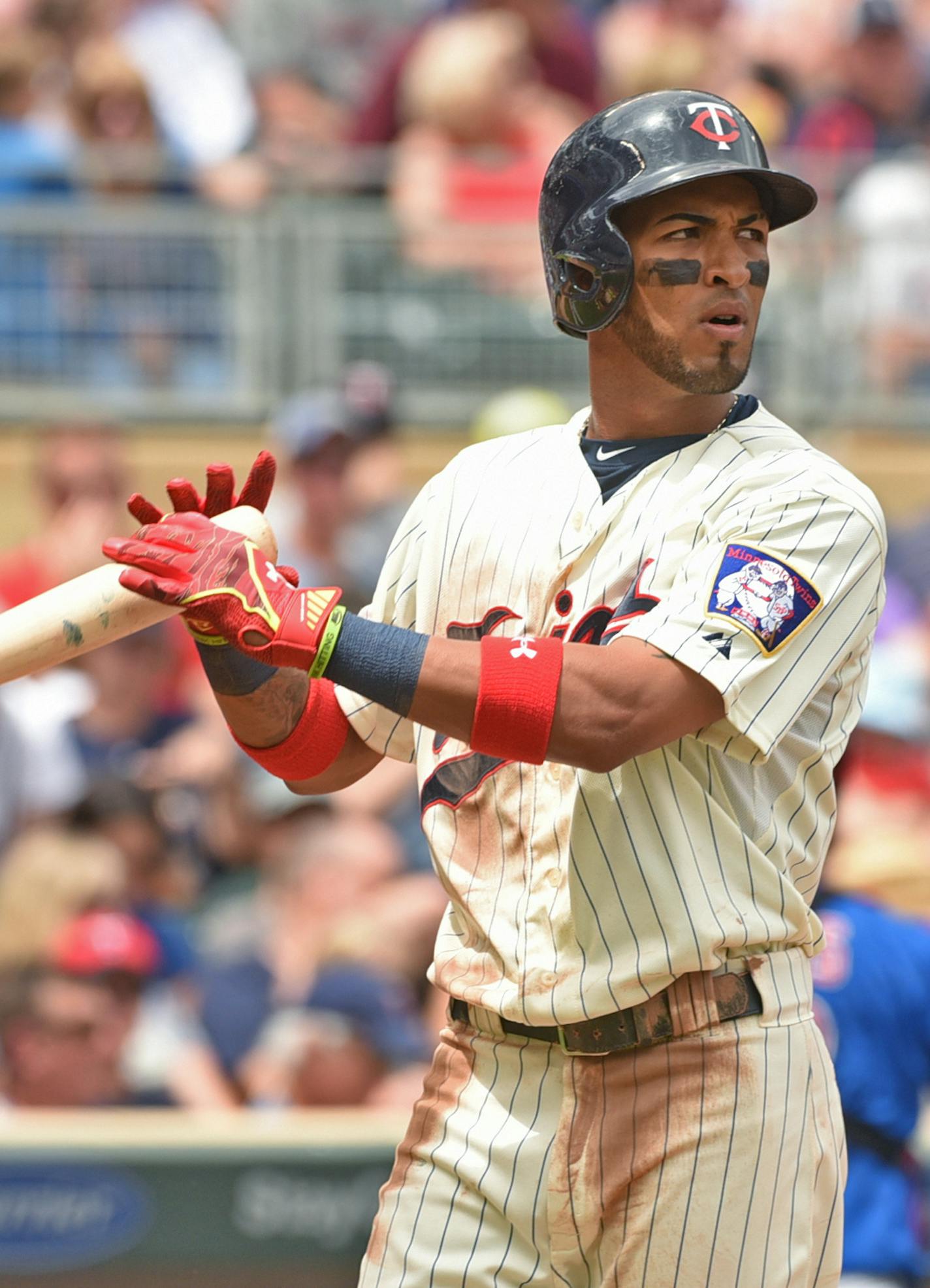 Twins batter Eddie Rosario heads back to the dugout after getting rung up by home plate umpire Manny Gonzalez against the Cubs in the third inning of a baseball game, Saturday June 20, 2015, in Minneapolis. (AP Photo/Richard Marshall)