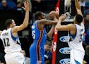 Oklahoma City's Kevin Durant looked to pass between the Timberwolves' Tayshaun Prince, left, and Karl-Anthony Towns in the first quarter during a game