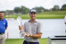 Michael Thompson holds the trophy after winning the 3M Open golf tournament in Blaine, Minn., Sunday, July 26, 2020. (AP Photo/Andy Clayton- King)
