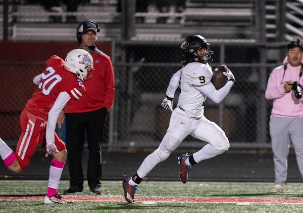Andover's D'Mario Davenport (9) breaks away from Armstrong's defensive back Bram Hetteen (20) to run for a touchdown in the second half. Robbinsdale A