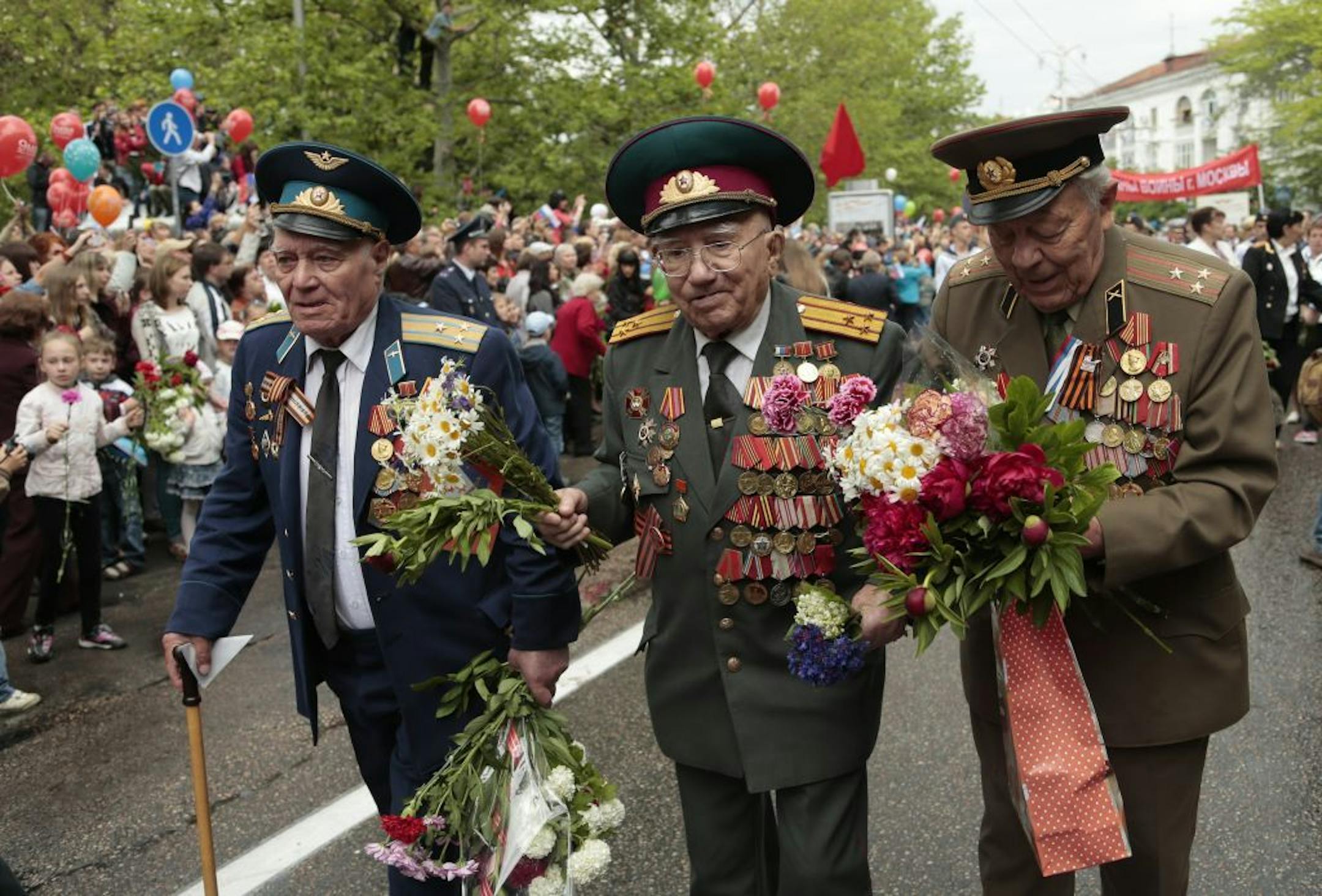 WWII veterans walk during a Victory Day military parade in Sevastopol, Crimea, Friday, May 9, 2014. Crimea, which hosts a major Russian Black Sea Fleet base, is also set to hold a massive navy parade in the port of Sevastopol, celebrating the Russian takeover.