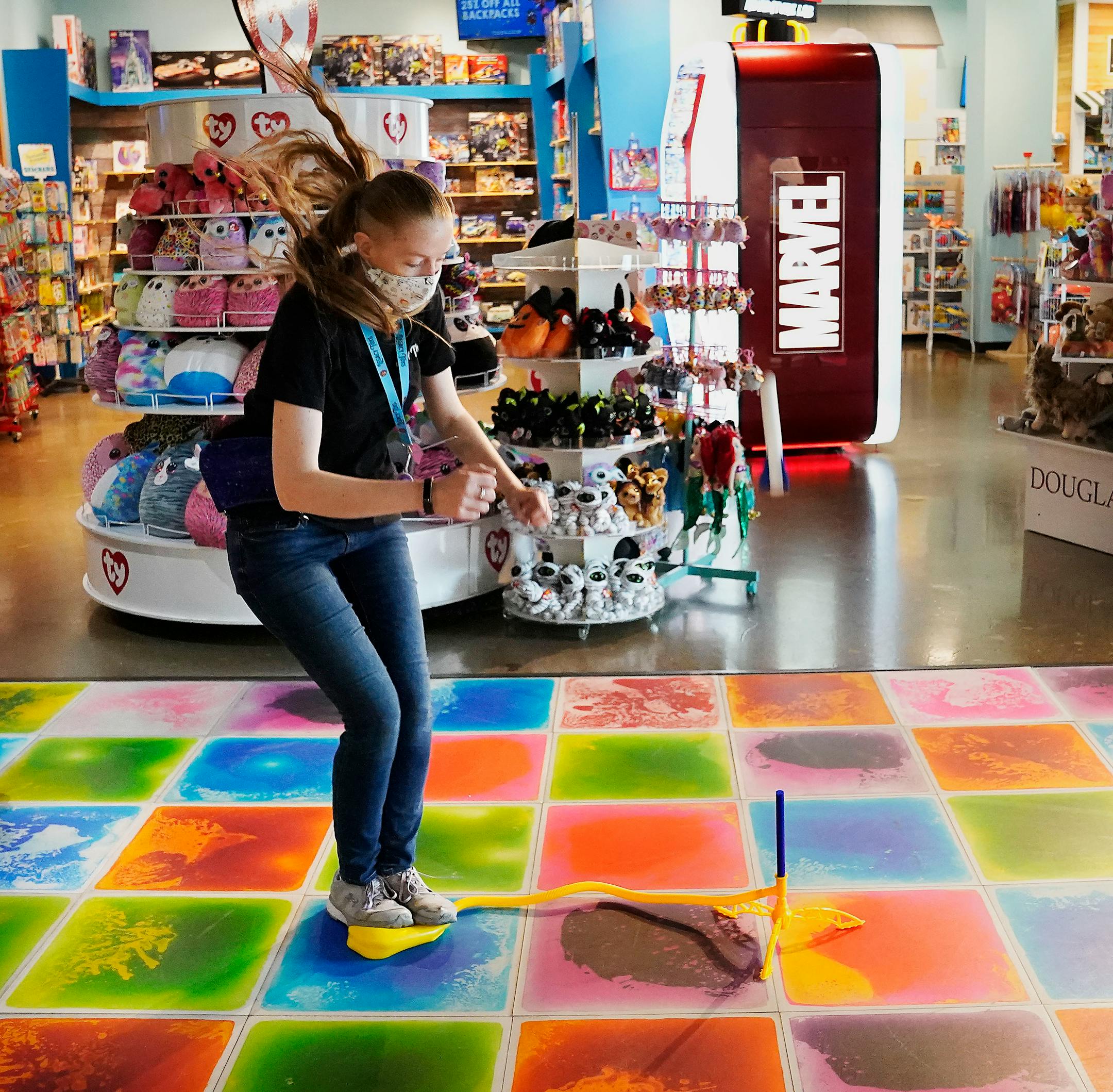 JayLynn Seidel, store manager at Legacy Toys in the Mall of America, demonstrated how a stomp rocket toy works as she leapt into the air before coming down on an air launch pad that propels the rocket skyward.