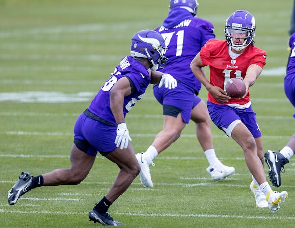 Minnesota Vikings rookies, including quarterback Kellen Mond, right, practice during NFL football rookie minicamp Friday, May 14, 2021, in Eagan, Minn