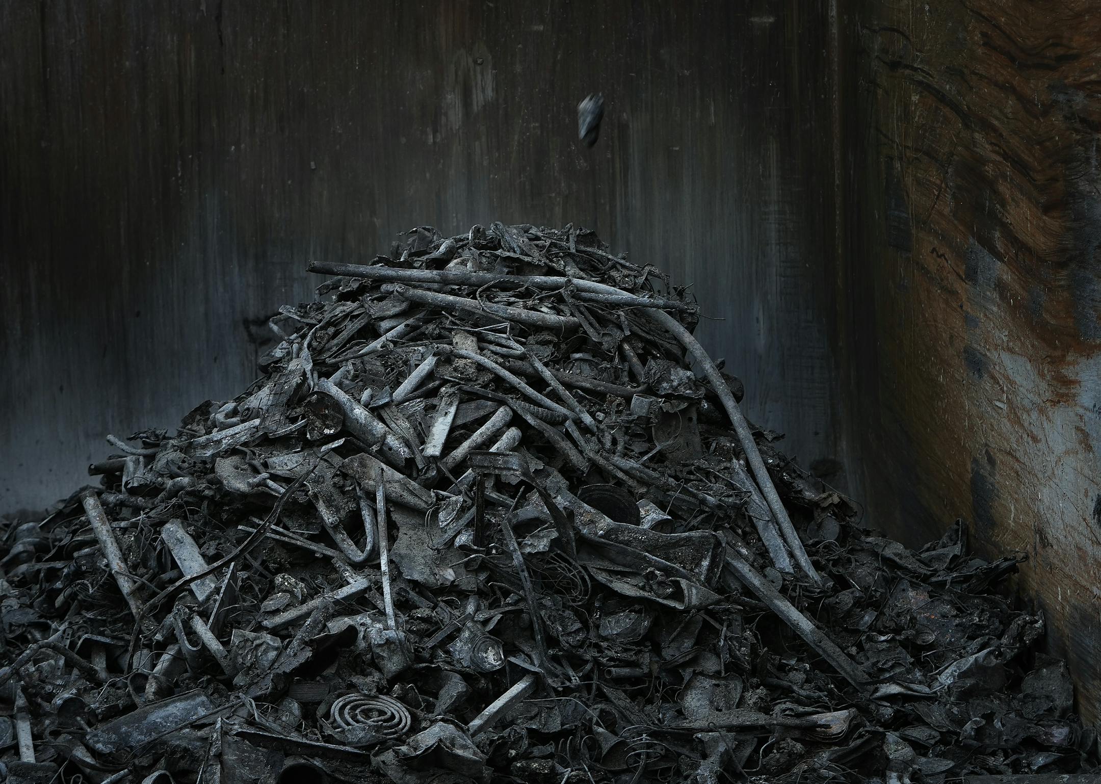 A piece of metal recovered in the recycling process falls onto a pile of recovered metal at Hennepin Energy Recovery Center.
