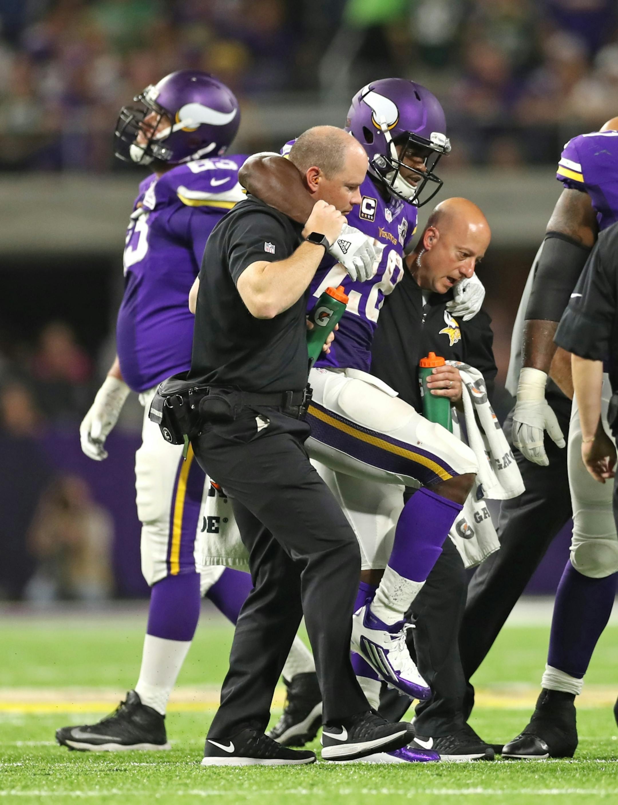Adrian Peterson gets taken off the field after an injury in the 3rd quarter. The Minnesota Vikings open the new US Bank Stadium for their first home regular season game against the Green Bay Packers. Here,