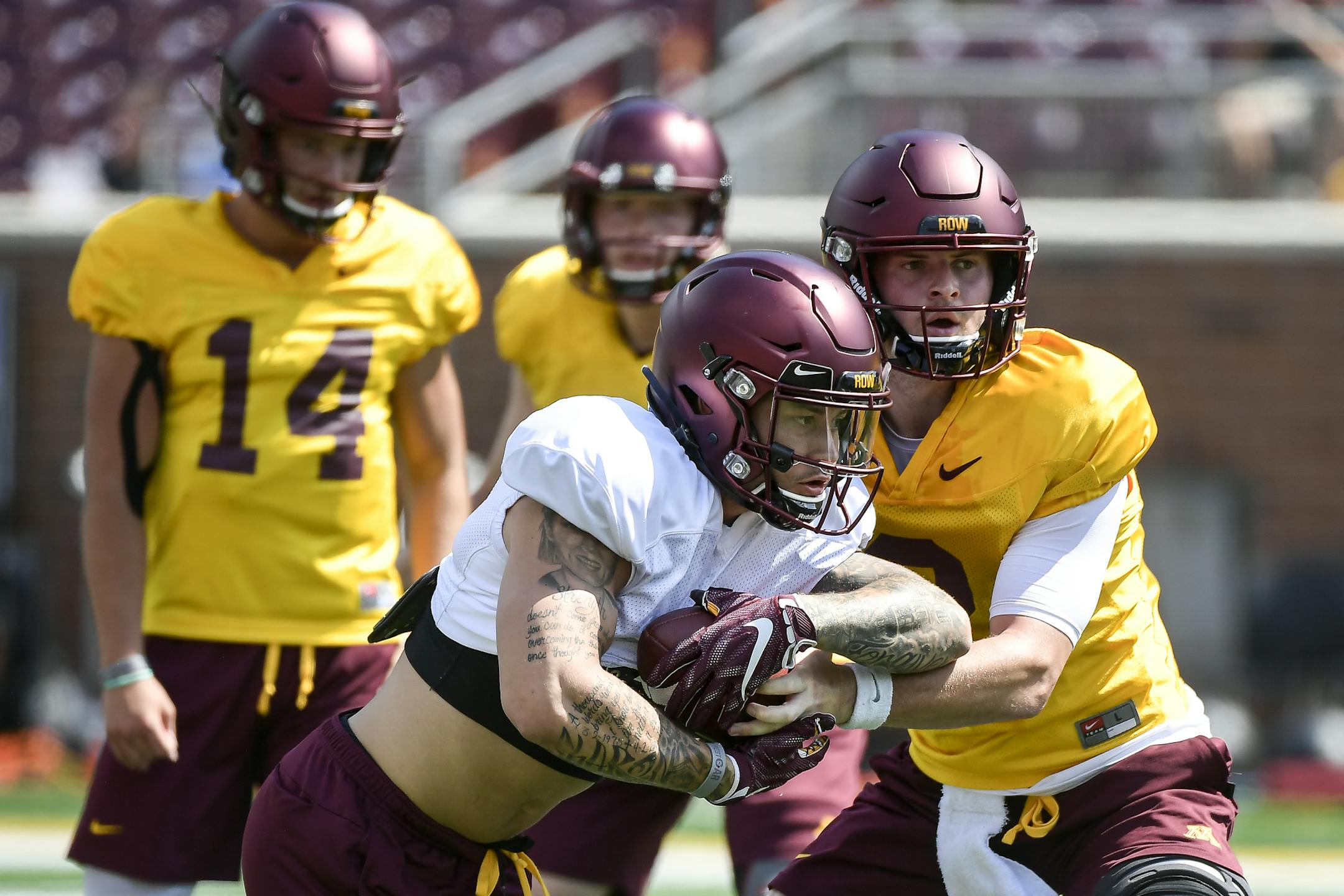 Minnesota Golden Gophers quarterback Tanner Morgan (2) handed off the ball to running back Shannon Brooks (4) during practice Saturday. ] Aaron Lavinsky ¥ aaron.lavinsky@startribune.com The University of Minnesota Golden Gophers football team held an open practice on Saturday, Aug. 3, 2019 at TCF Bank Stadium in Minneapolis, Minn.