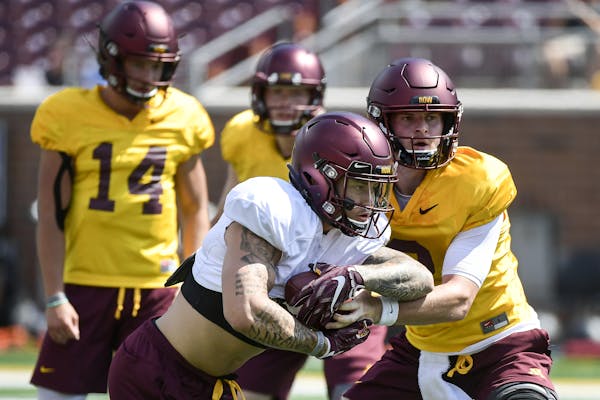 Minnesota Golden Gophers quarterback Tanner Morgan (2) handed off the ball to running back Shannon Brooks (4) during practice Saturday. ] Aaron Lavins