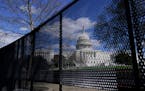 The U.S. Capitol is seen behind security fencing on Capitol Hill in Washington in April. 