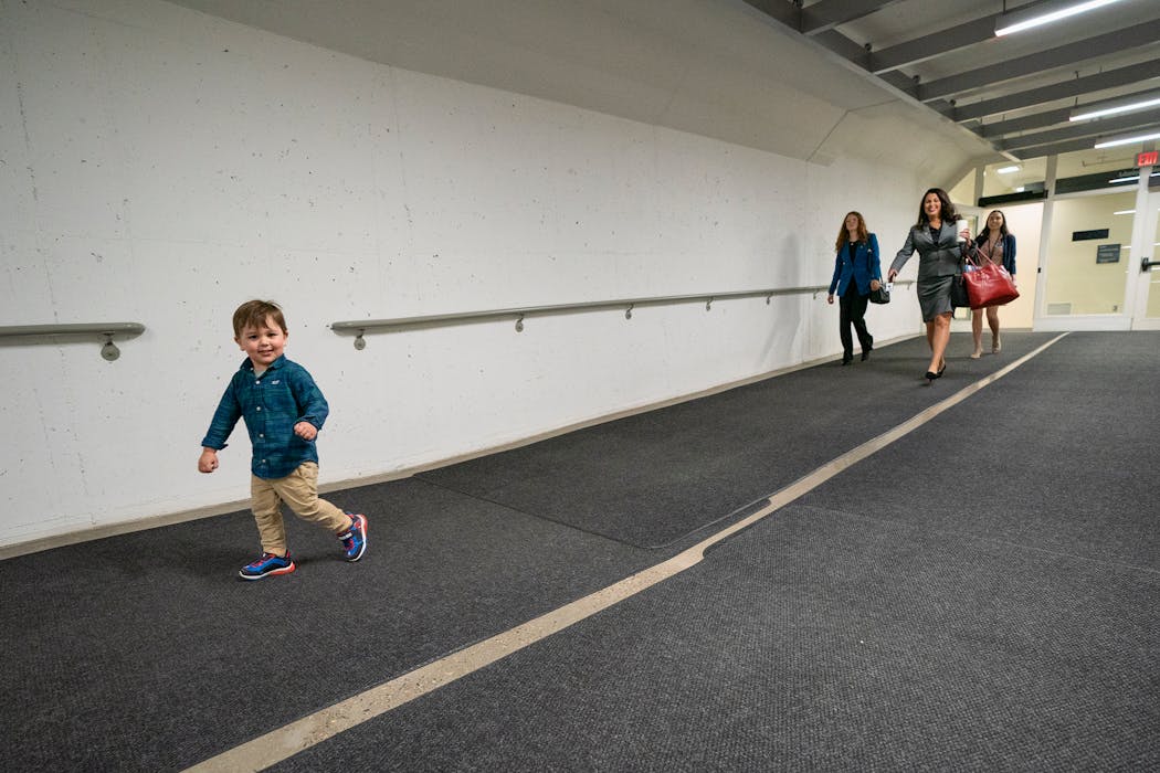 Sen. Julia Coleman tries to keep up with her son Adam running in the Senate tunnel on April 23, 2022. Coleman had an issue with child care that day.