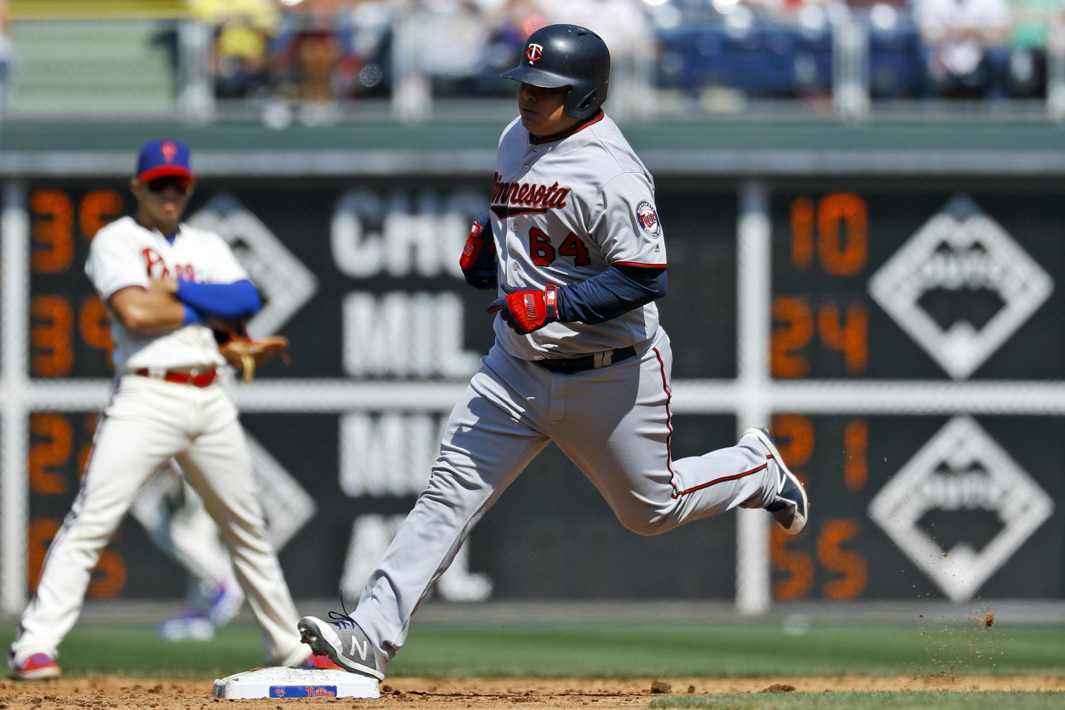 Minnesota Twins' Willians Astudillo, right, rounds the bases past Philadelphia Phillies second baseman Cesar Hernandez after hitting a home run off starting pitcher Jake Arrieta during the third inning of a baseball game, Saturday, April 6, 2019, in Philadelphia. (AP Photo/Matt Slocum)