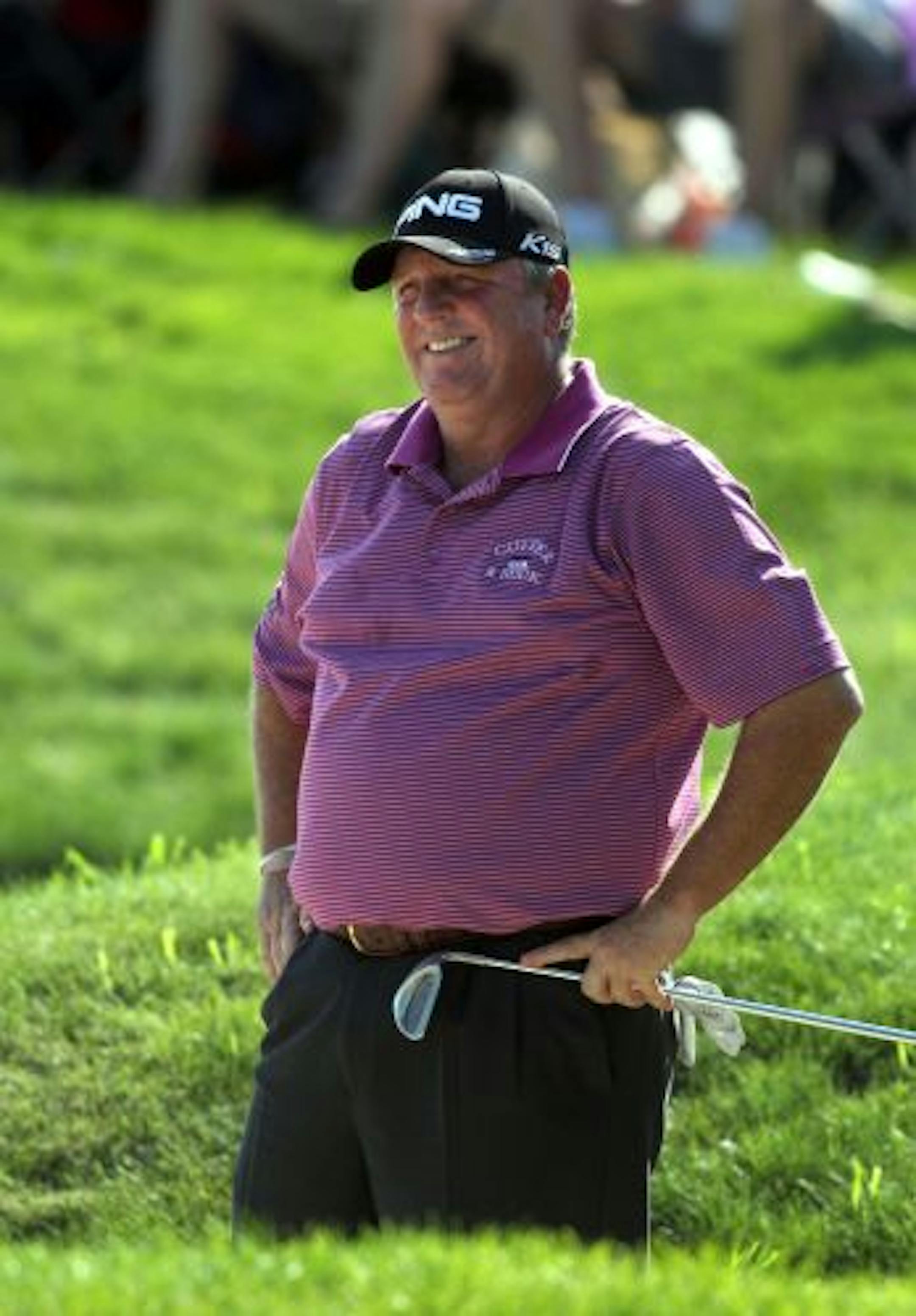Mark Calcavecchia, looks frustrated after hitting his bunker shot on 18. Calcavecchia bogeyed the 18th, ending the day at 14 under par and tied with David Frost.