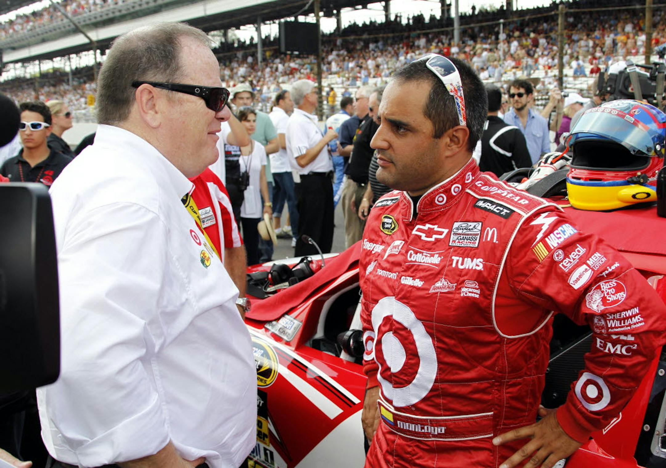 July 25, 2010: Team owner Chip Ganassi, left, talks with Juan Pablo Montoya.
