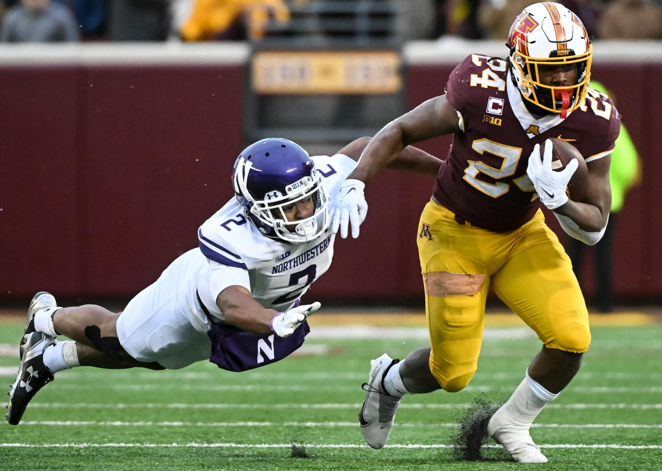 Minnesota Gophers running back Mohamed Ibrahim (24) breaks a tackle by Northwestern Wildcats defensive back Cameron Mitchell (2) during the first half.