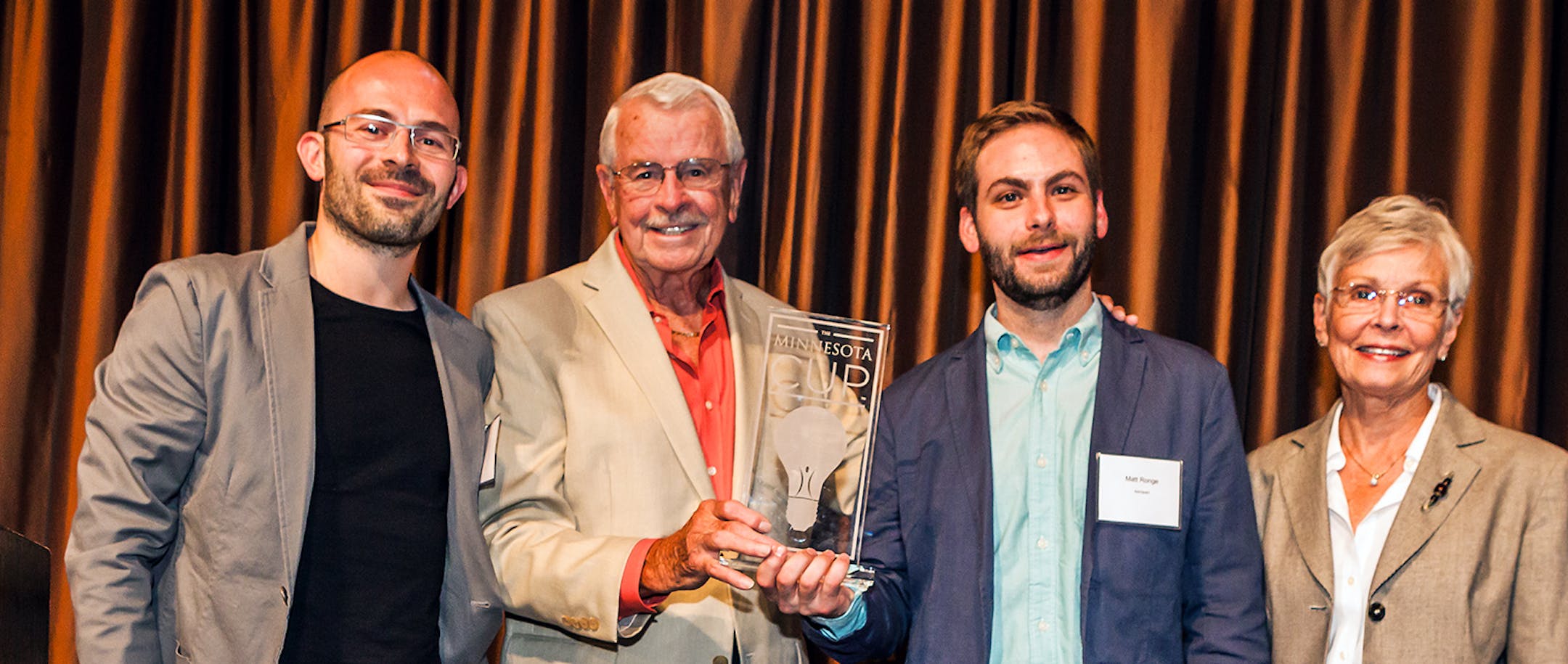 Minnesota Cup Grand Prize winners Giovanni Donelli (left) and Matt Ronge (third from left) of Astropad with cup founding sponsors David and Carolyn Cleveland.