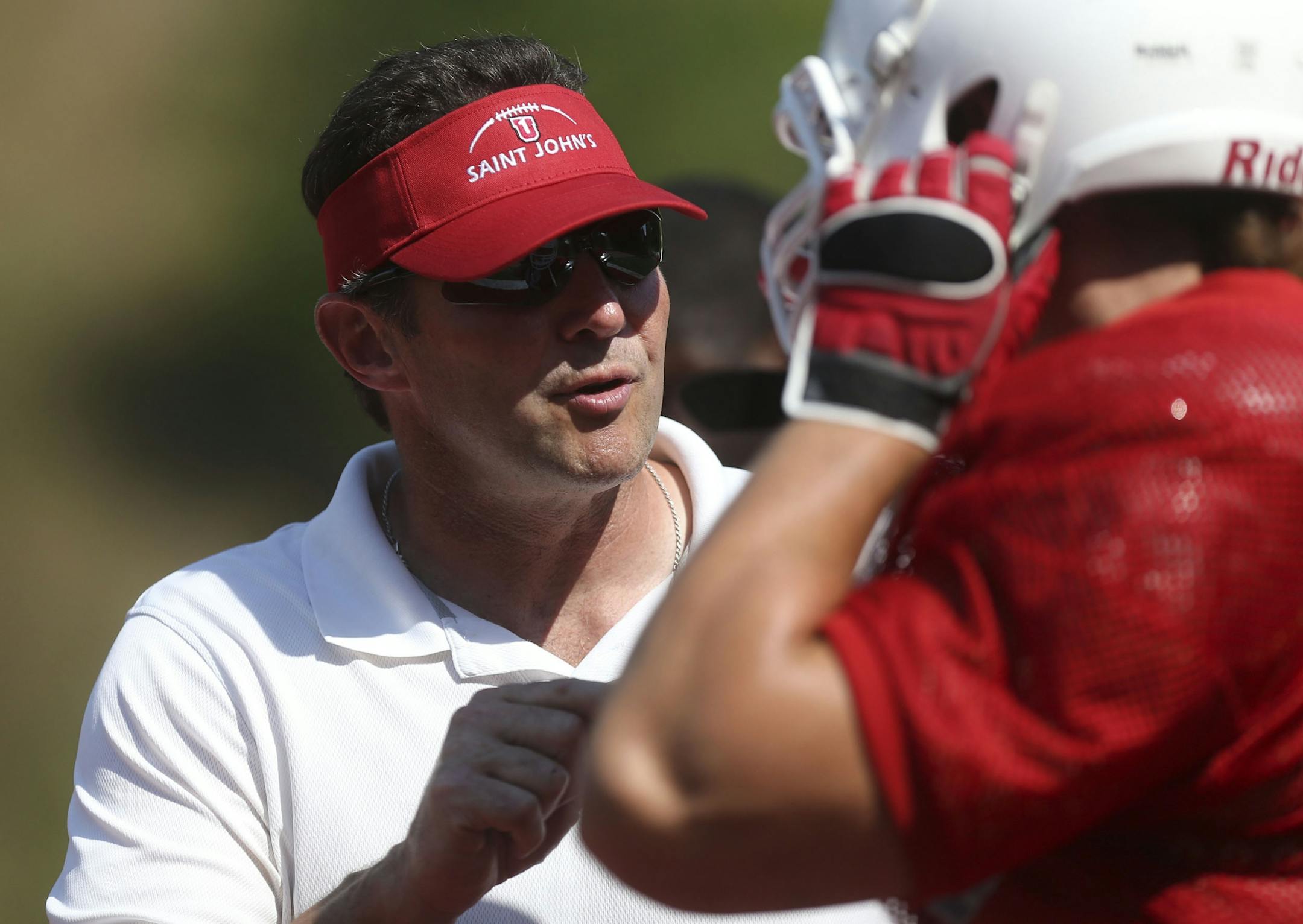 Head Coach Gary Fasching praised defense lineman Nate Blenker after a good pass rush during practice at St John's University in Collegeville Min., Wednesday, August 21, 2013.