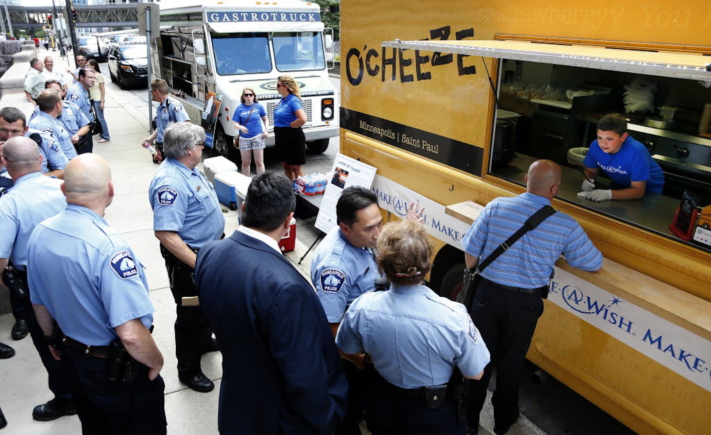 Officers line up at the O'Cheeze food truck for a special event at Minneapolis City Hall.