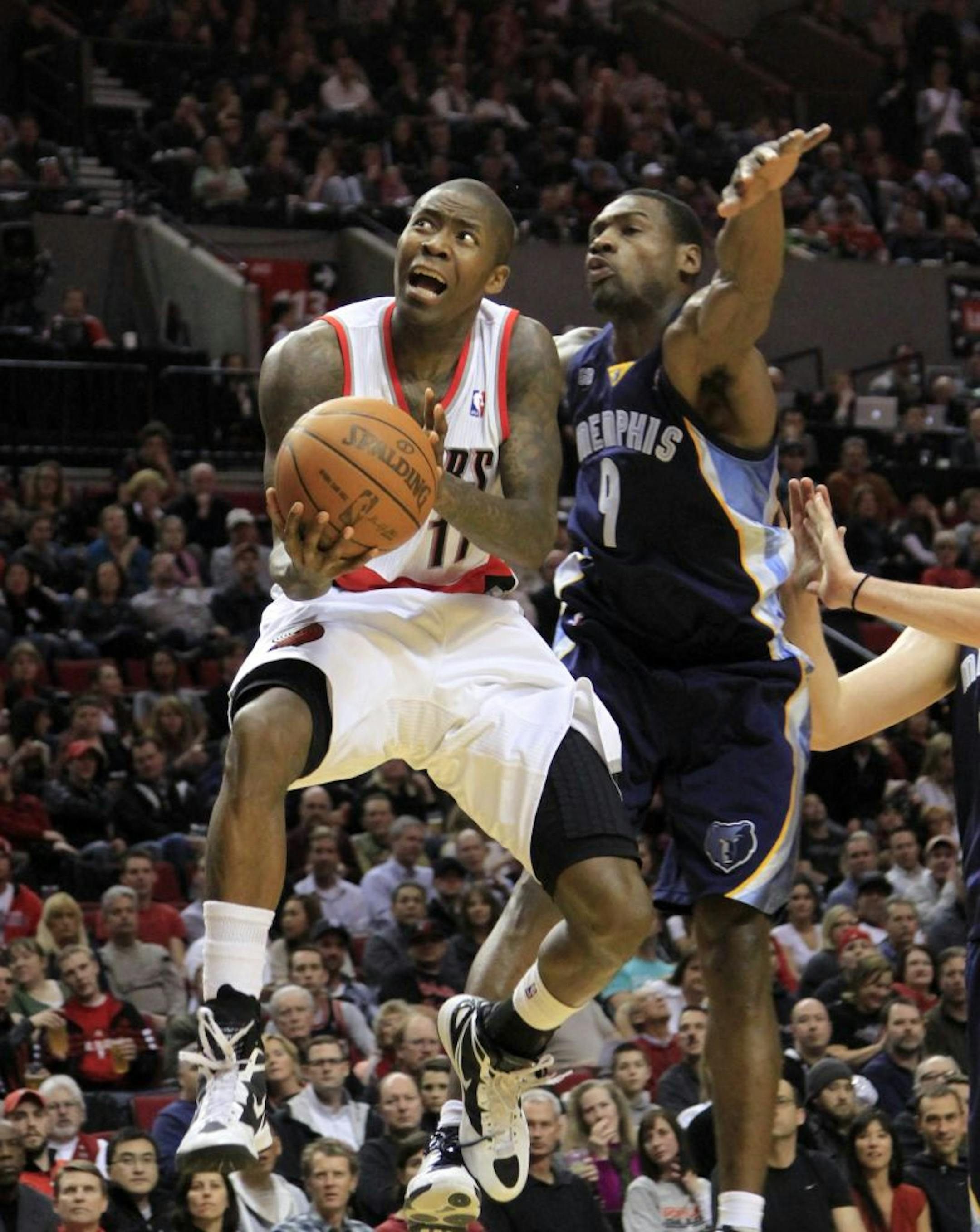 Portland Trail Blazers guard Jamal Crawford, left, flies to the hoop past Memphis Grizzlies guard Tony Allen during the second half of their NBA basketball game in Portland, Ore., Tuesday, Jan. 24, 2012. Crawford came off the bench to score 15 points in the Blazers 97-84 win over the Grizzlies.